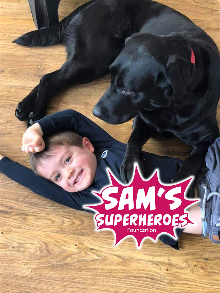 photo of Sam (a little boy who passed away from FIRES) and his black labrador Daisy,plus the Charity logo 'Sam's Superheroes' set up in his name