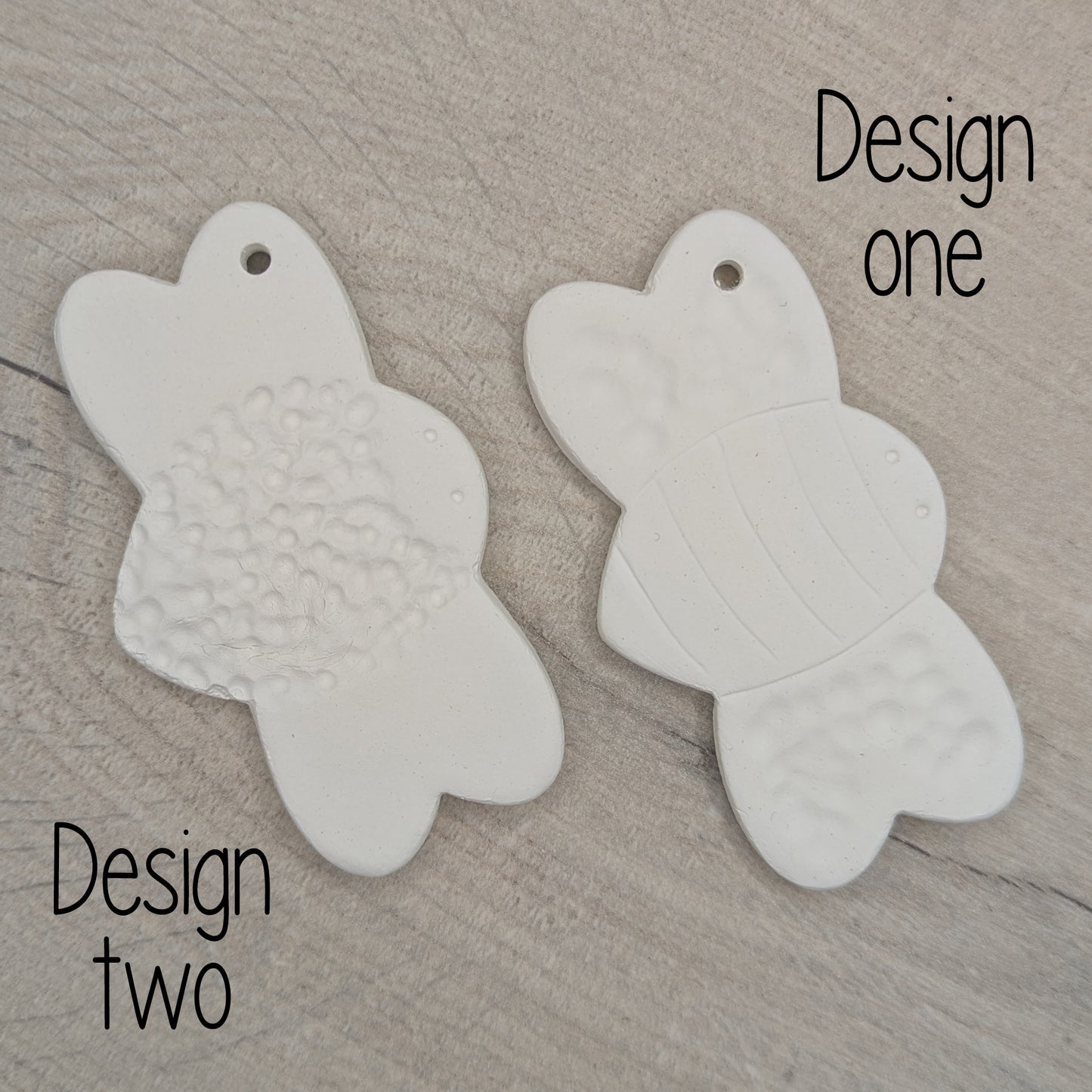two bumble bee clay decoration to show the two option of patterns available
