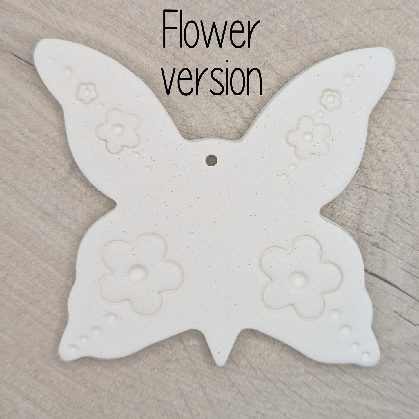 large air dried clay butterfly decoration, with a flower pattern stamped into the wings