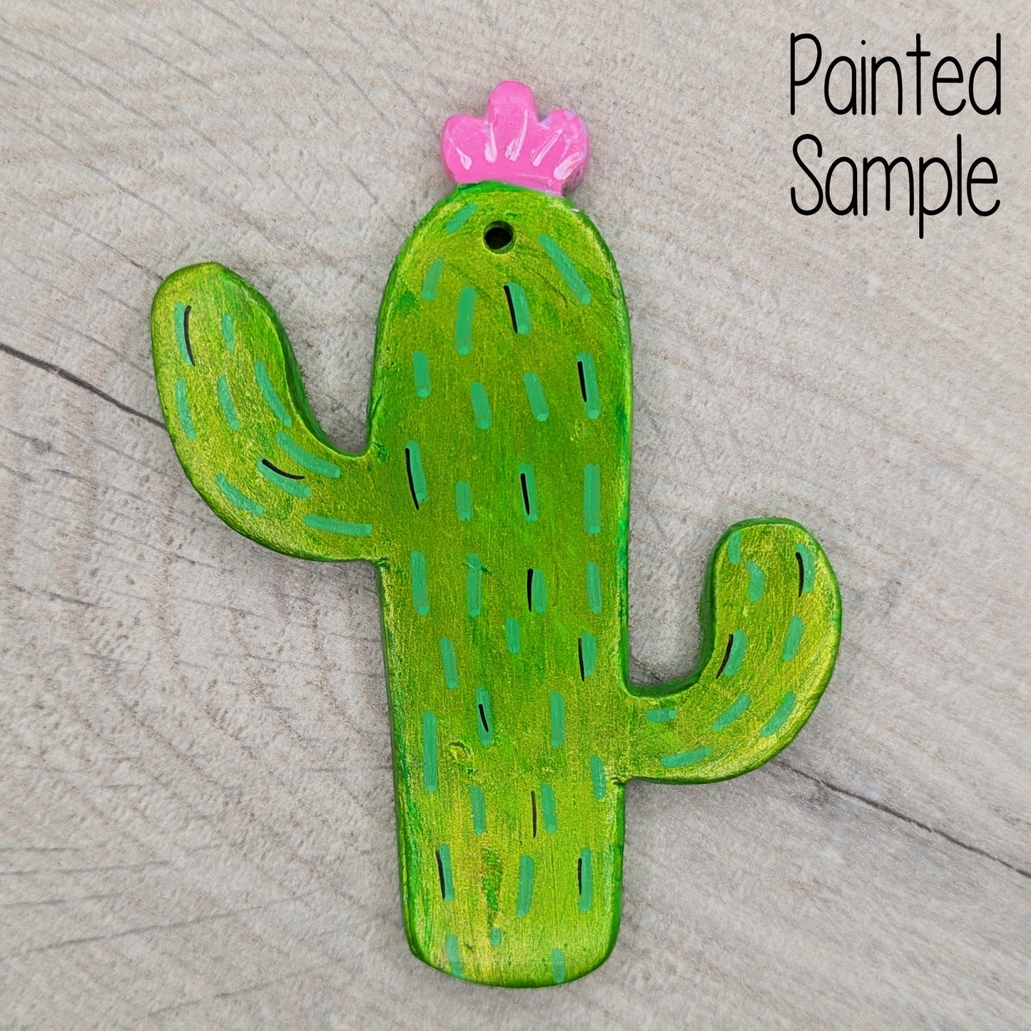 cactus clay decoration painted in metallic green acrylic paint, with pink flowers