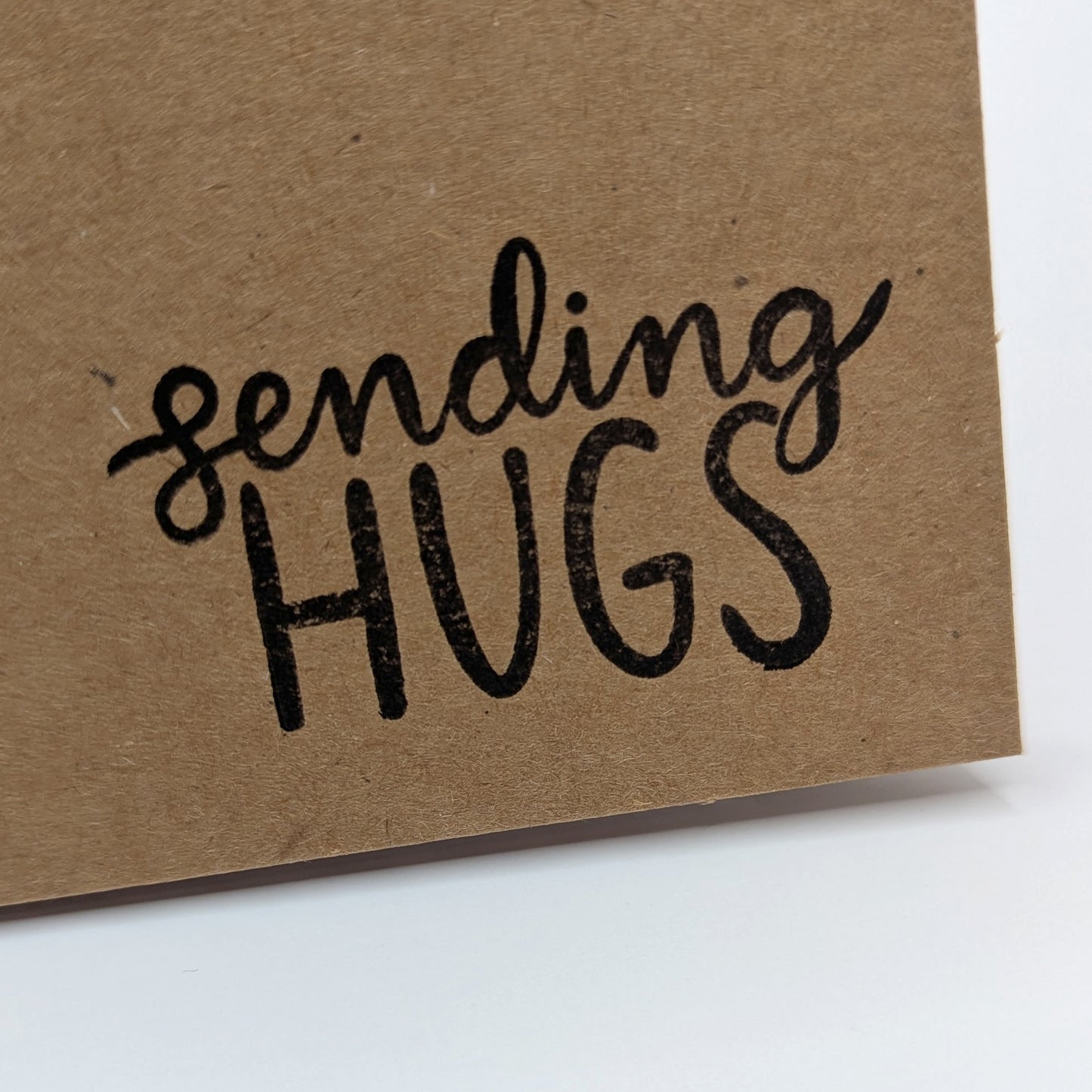 sending hugs stamped onto corner of kraft card