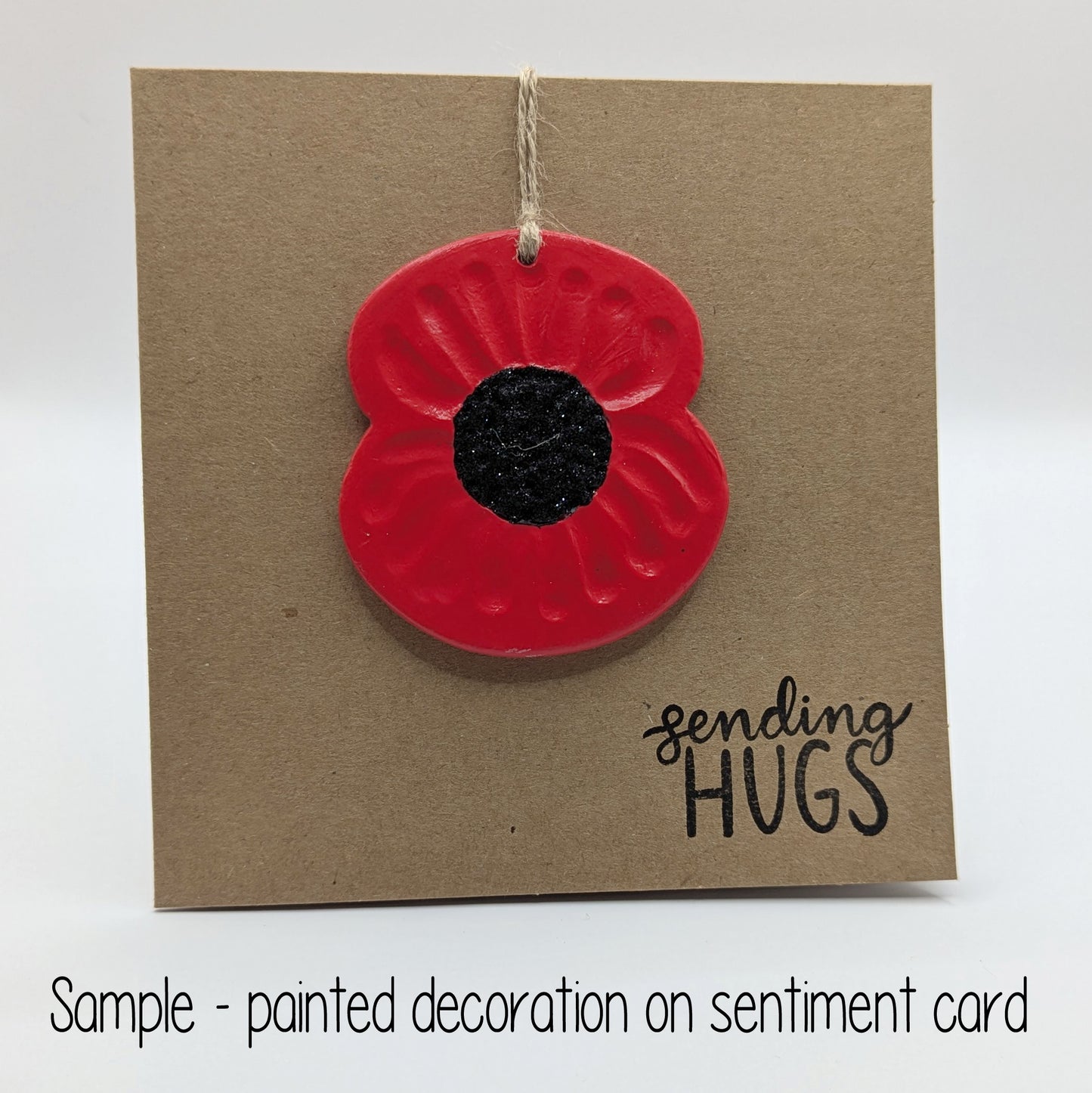 sending hugs card with painted red and black poppy attached to the front