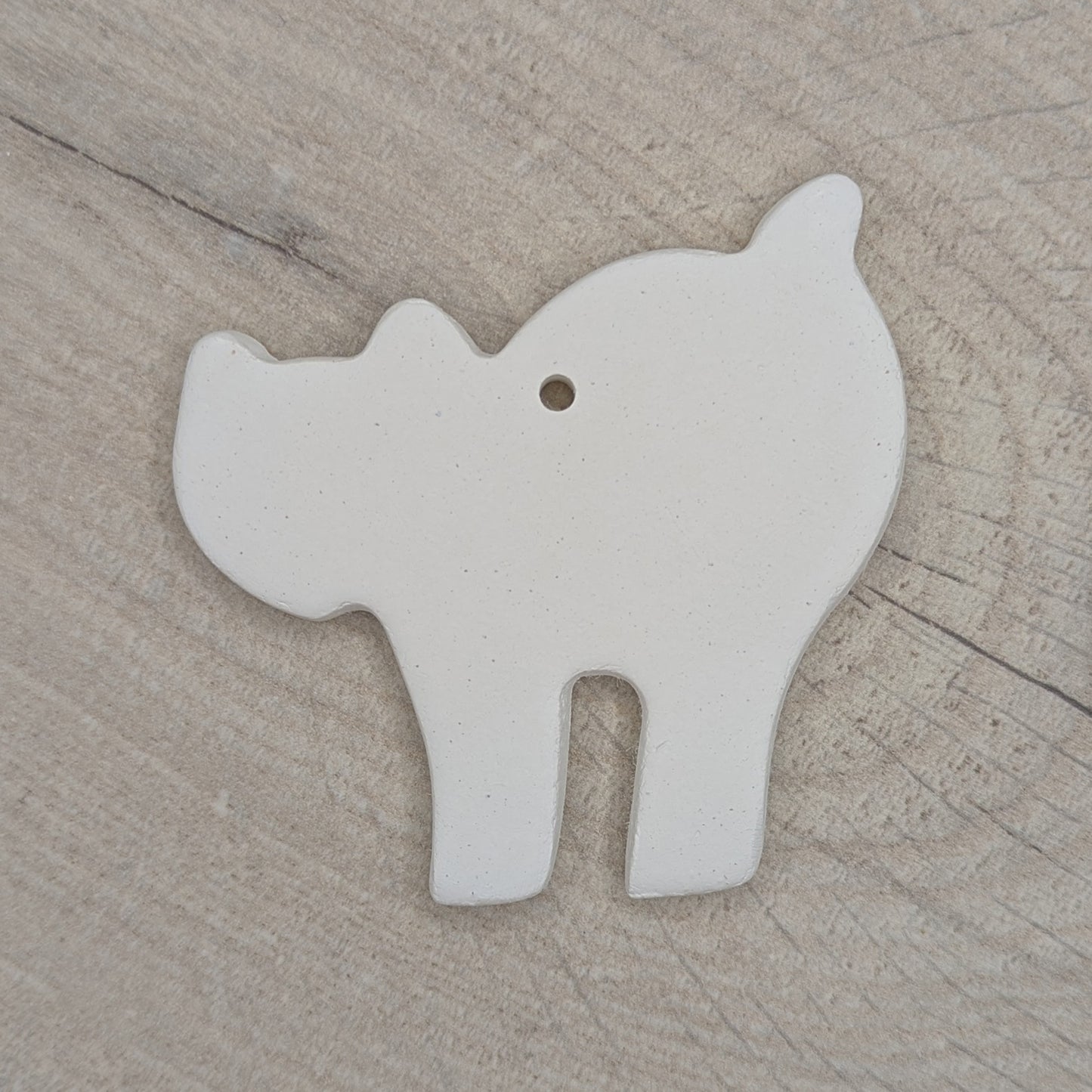 clay decoration in the shape of a a Halloween cat, with an arched back