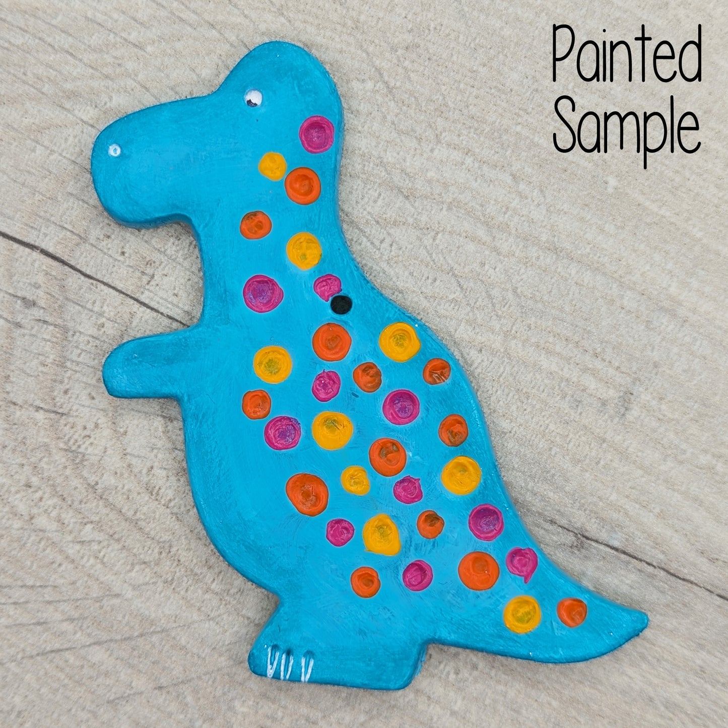 blue painted Tyrannosaurus dinosaur clay decoration with neon yellow, pink and orange spots