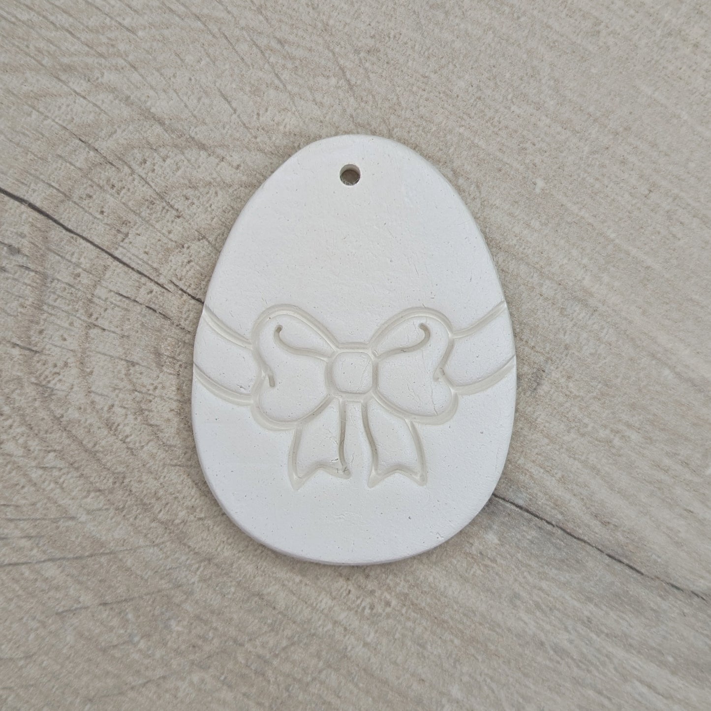 easter egg decoration with a bow design stamped into it