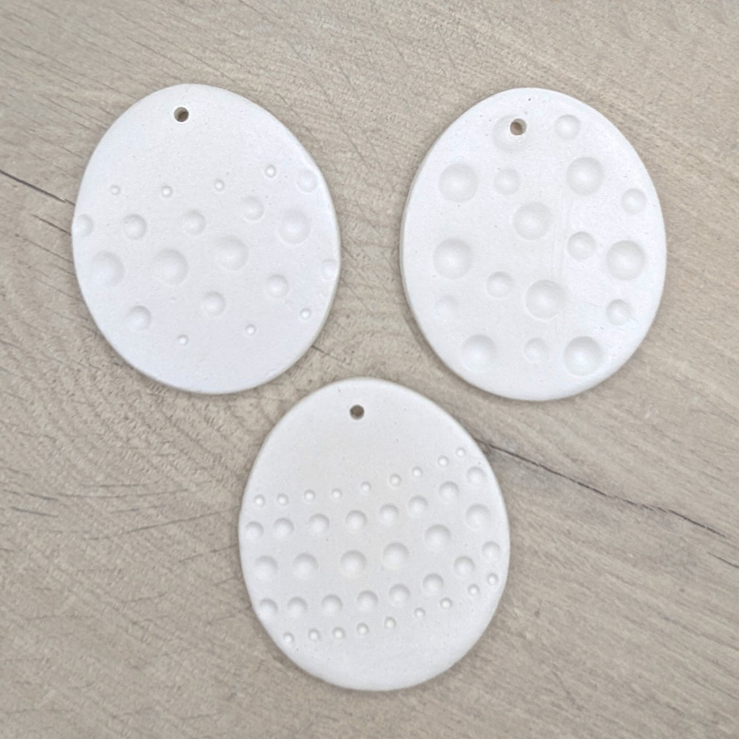 three easter eggs in different spotted patterns, made of air dried clay