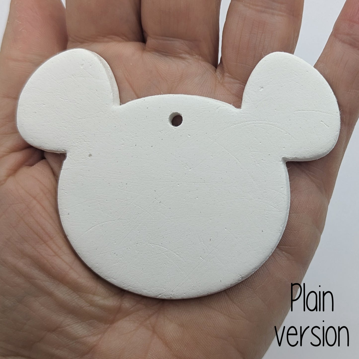 mouse or koala shaped clay decoration in a ladies hand to show scale