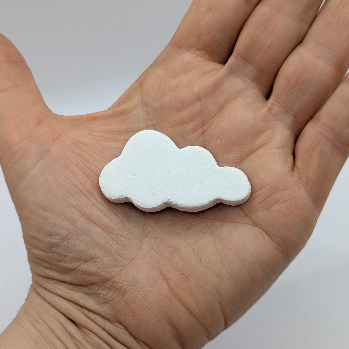 mini cloud clay decoration shown in palm of hand