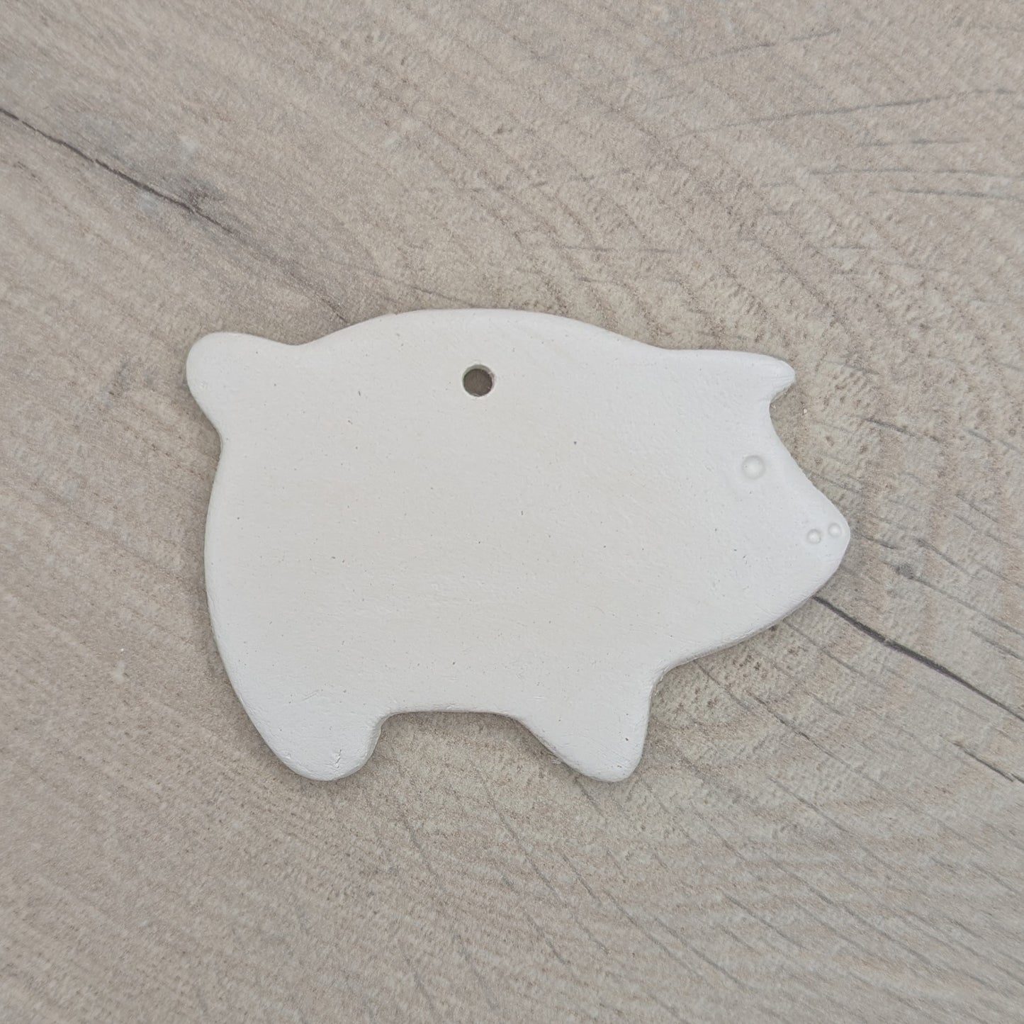 air dried clay decoration in the shape of a pig