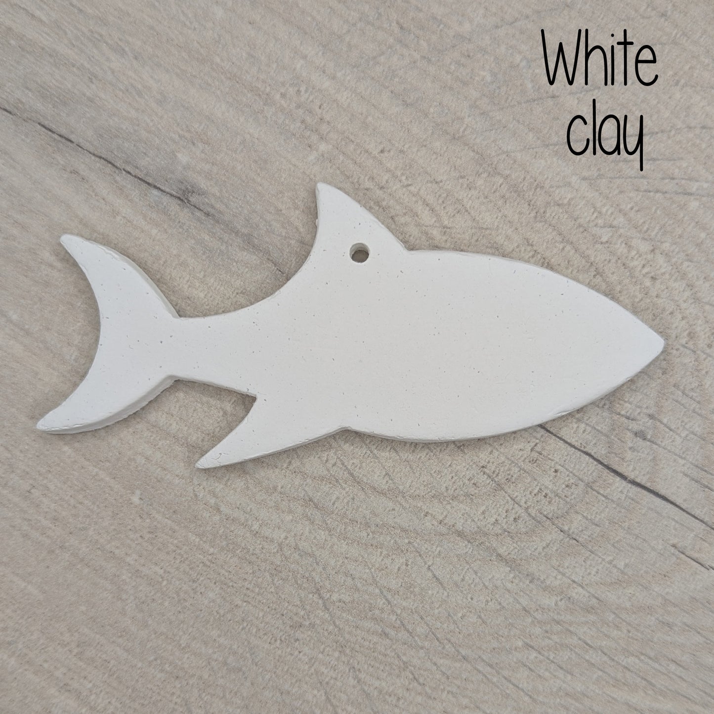 white air dried clay decoration in the shape of a shark