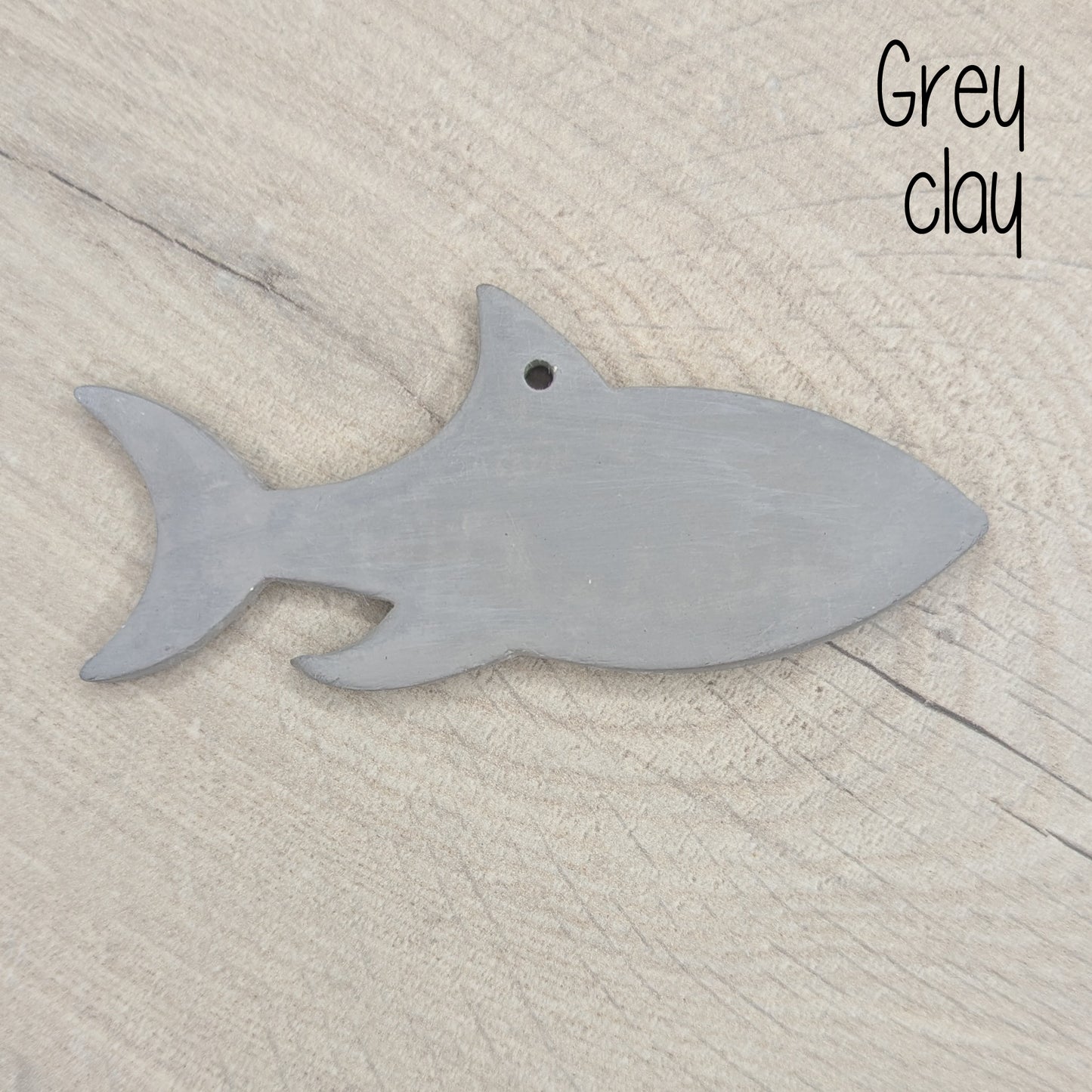 grey air dried clay decoration in the shape of a shark