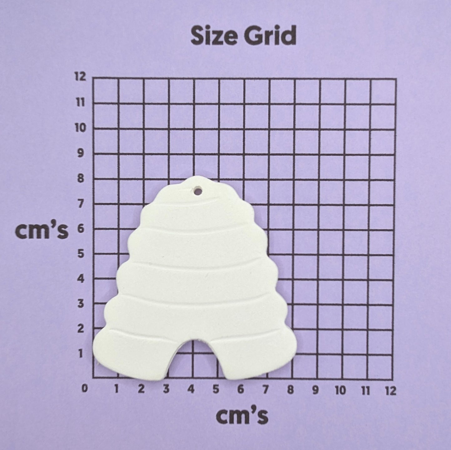 clay beehive decoration shown on size grid chart
