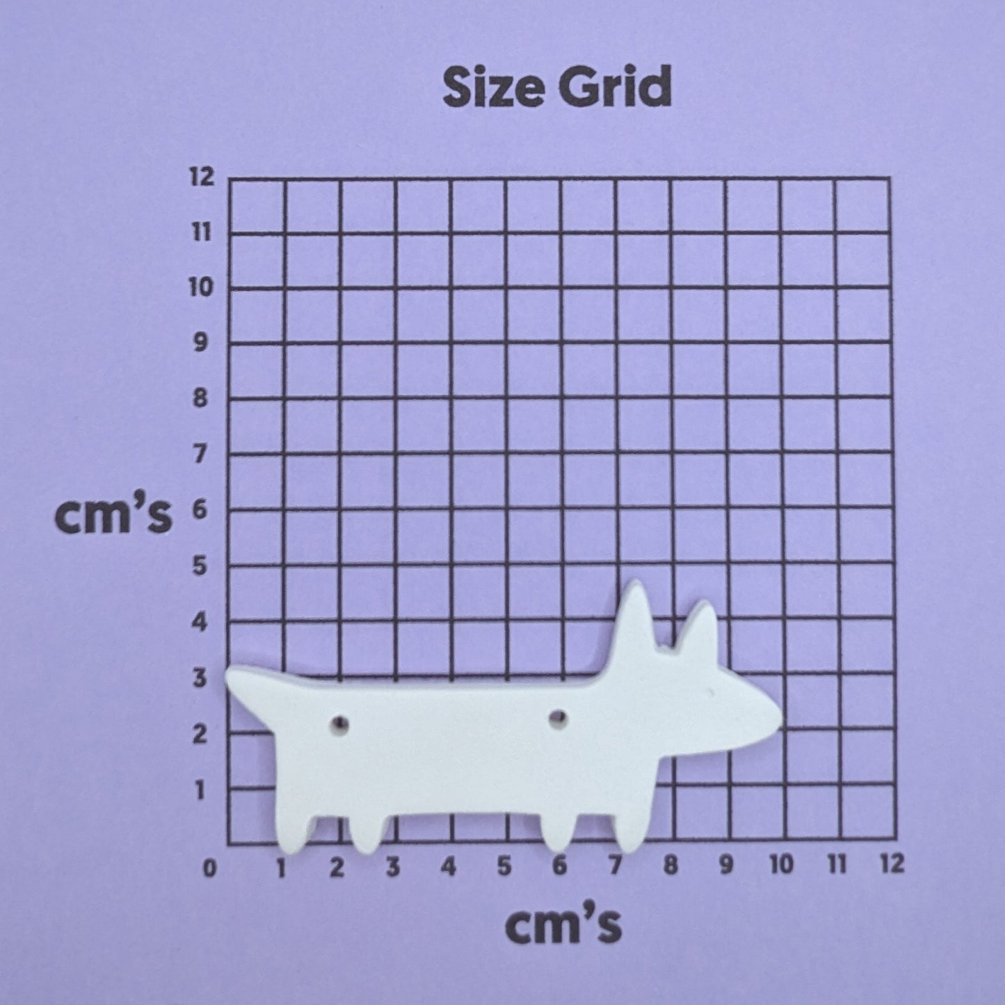 clay dog decoration on a size grid with measurements in centimeters