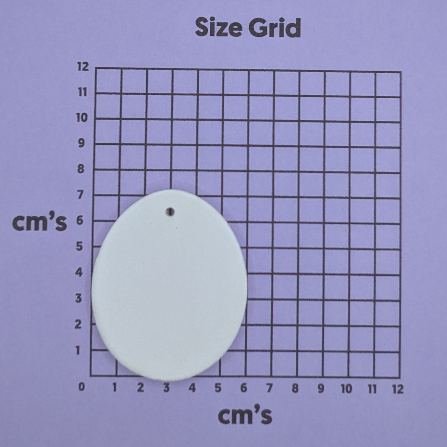 size chart with plain easter egg clay decoration on it to show size