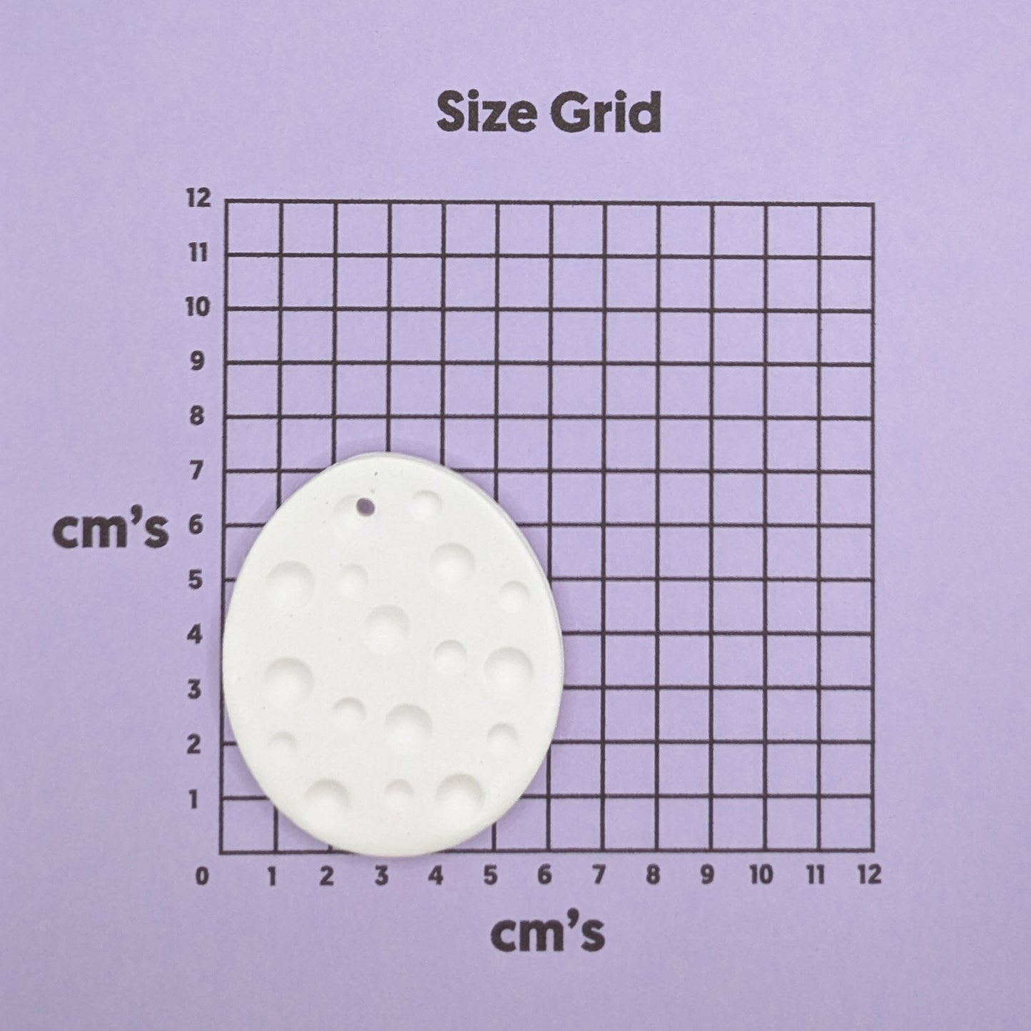 spotted easter egg on size grid to show size
