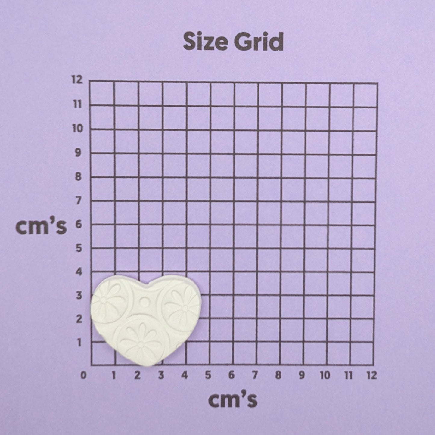 patterned heart clay decoration on size grid