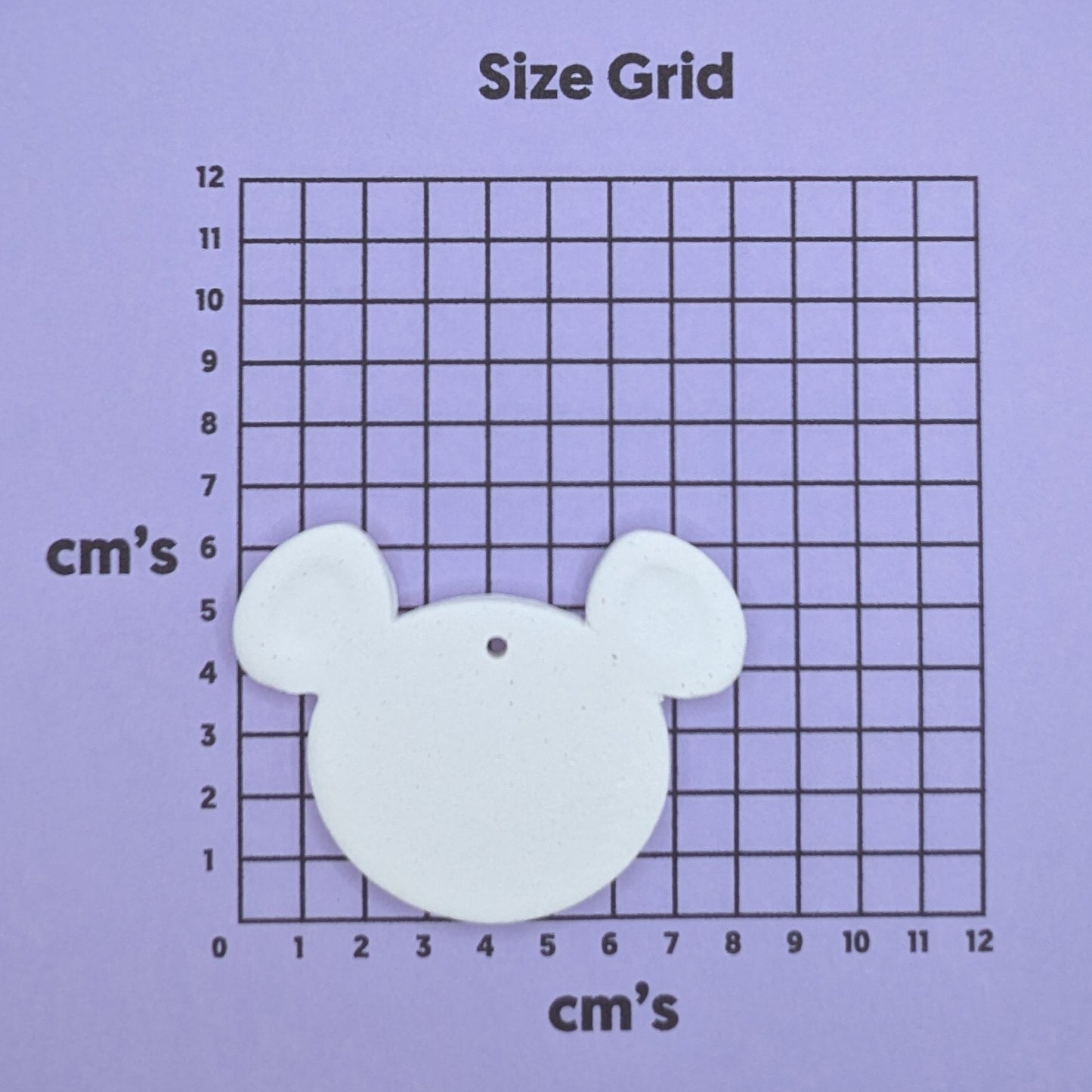clay koala / mouse decoration on a size grid with measurements in centimeters