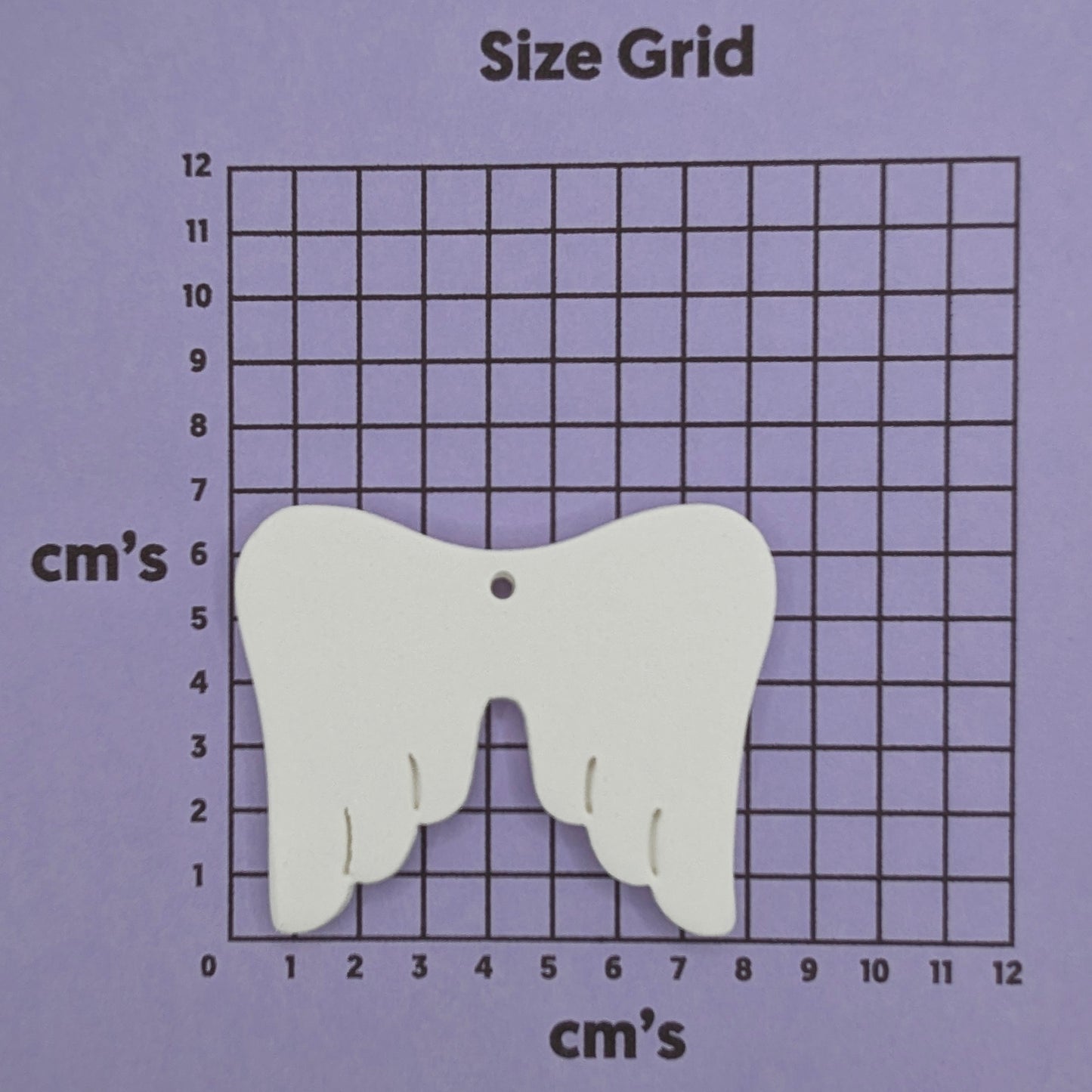 white air dried clay memorial angel wings, shown on cm size grid