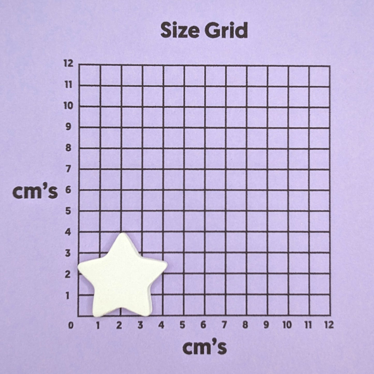 Size grid with a mini star shaped clay decoration on it