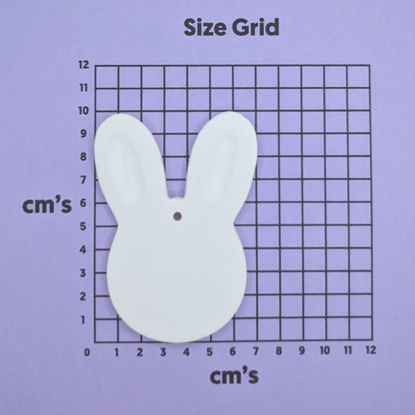 clay chunky face rabbit decoration on a size grid with measurements in centimeters