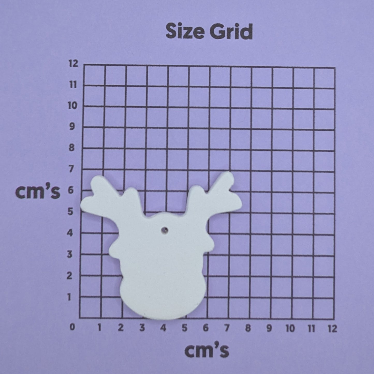 Size grid with a white reindeer shaped decoration on it
