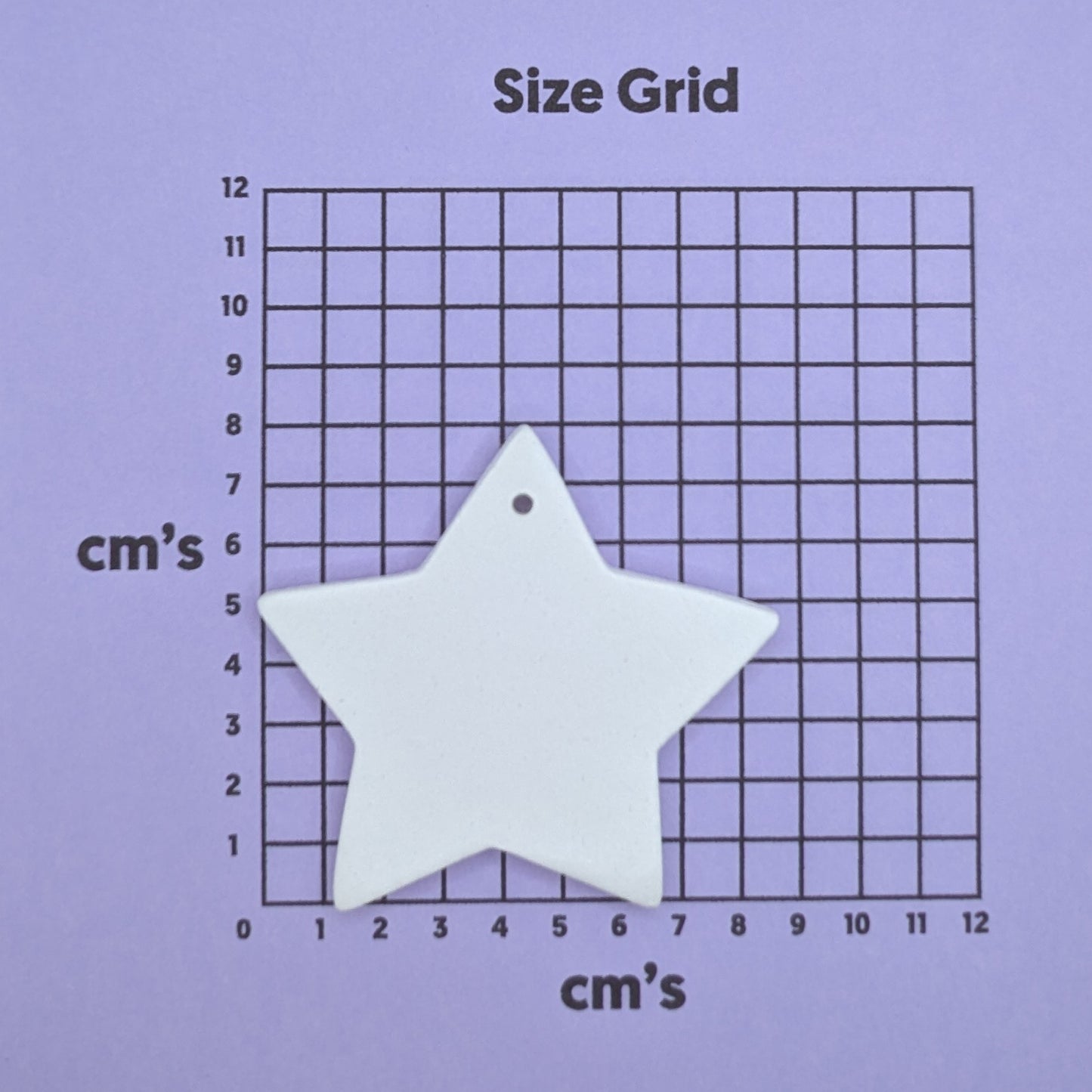 clay star decoration on a size grid with measurements in centimeters