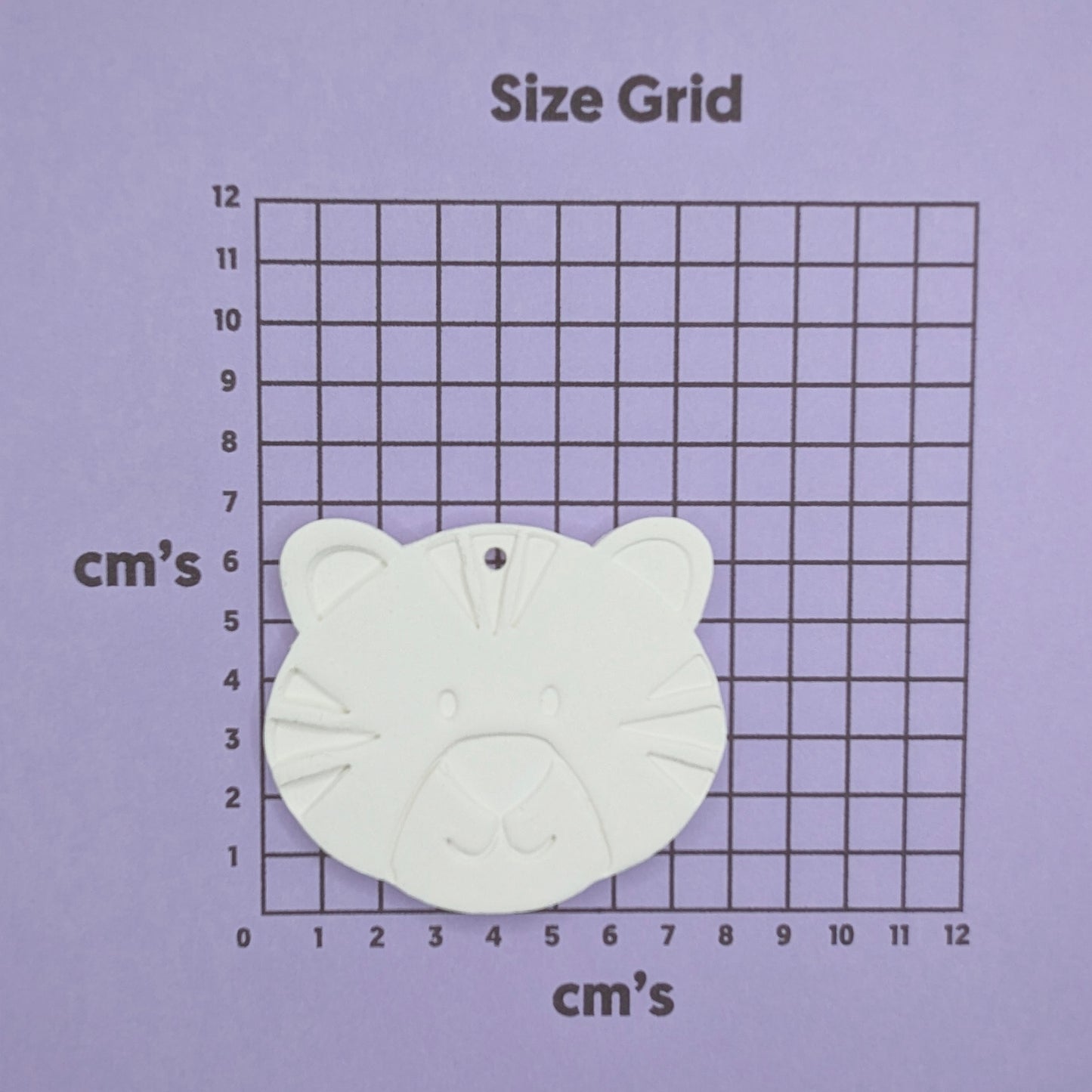Tiger cub clay decoration shown on a size chart in cm's to show size