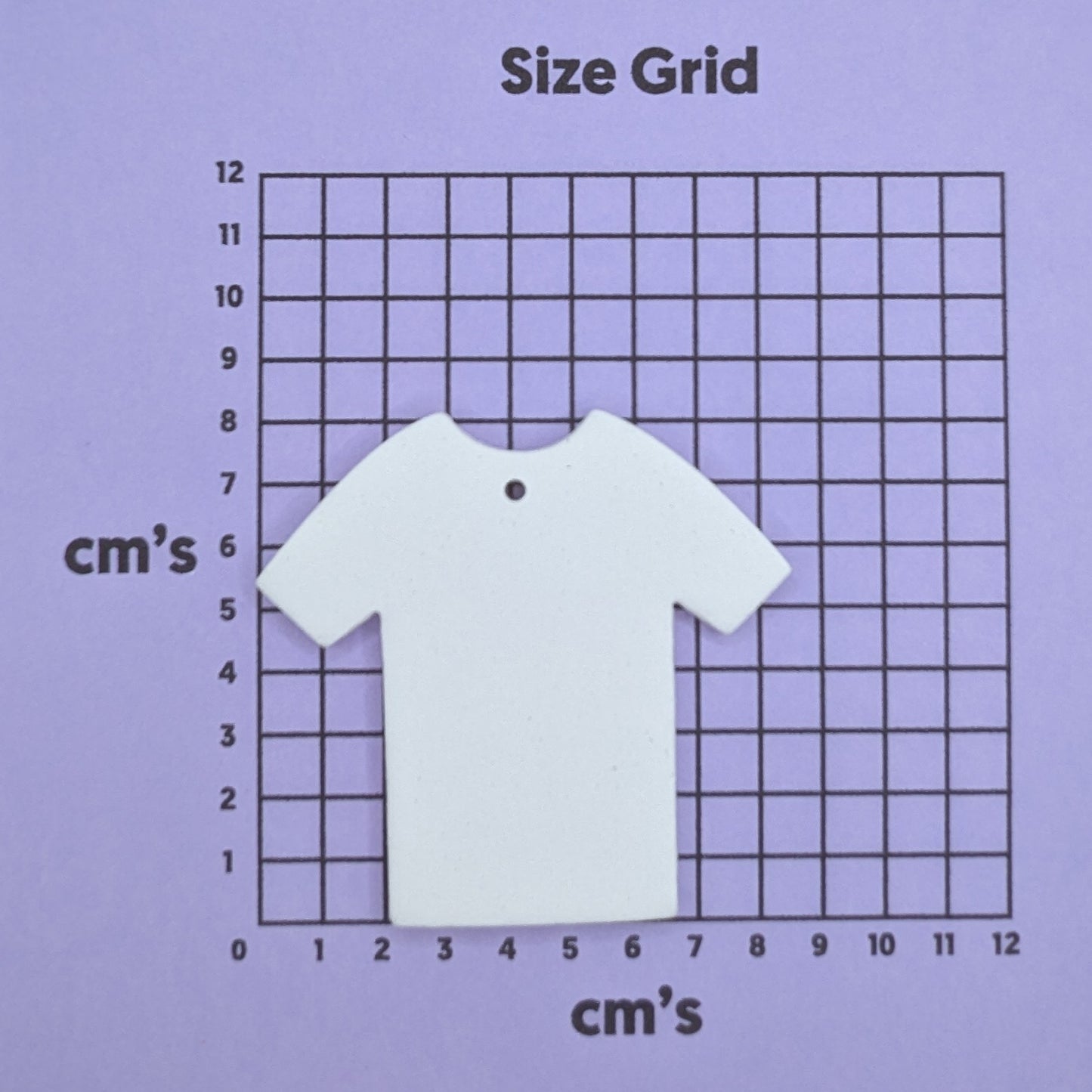 clay t shirt decoration on a size grid with measurements in centimeters