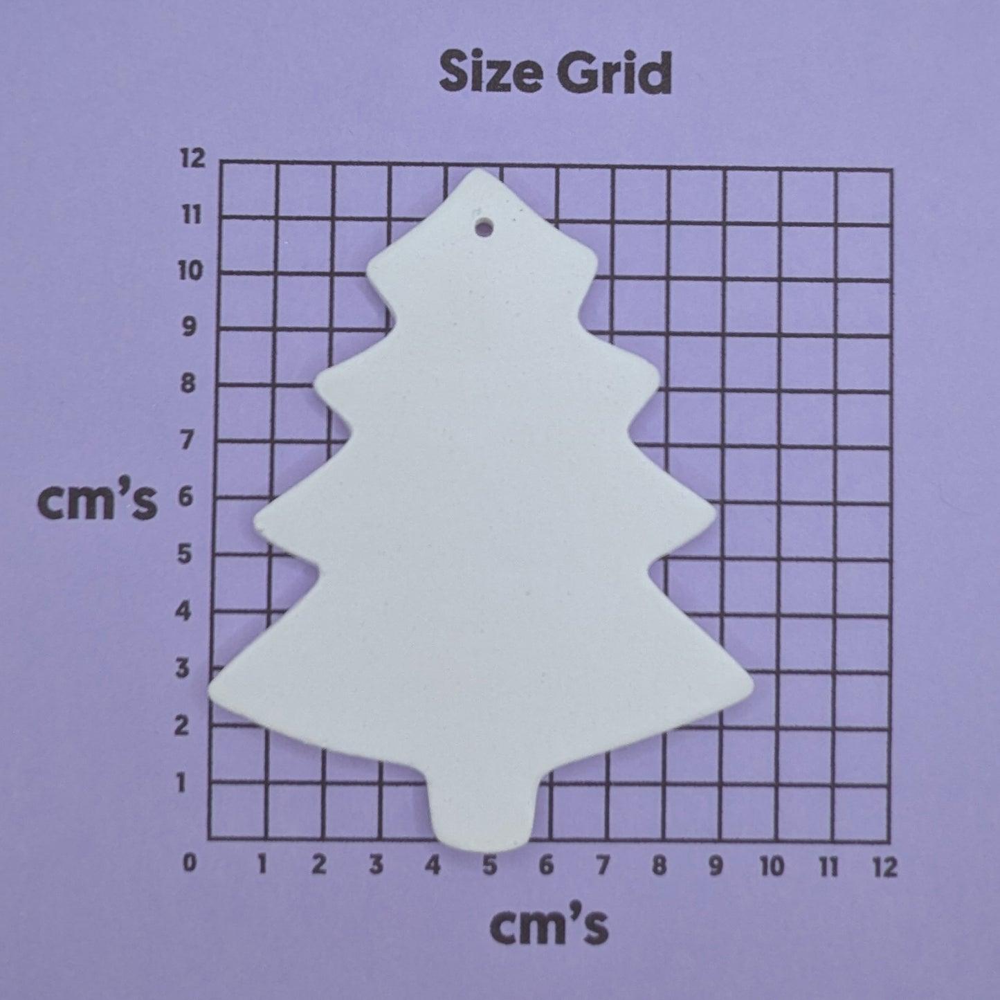 White tree-shaped decoration on a purple size grid with 'cm's' measurements