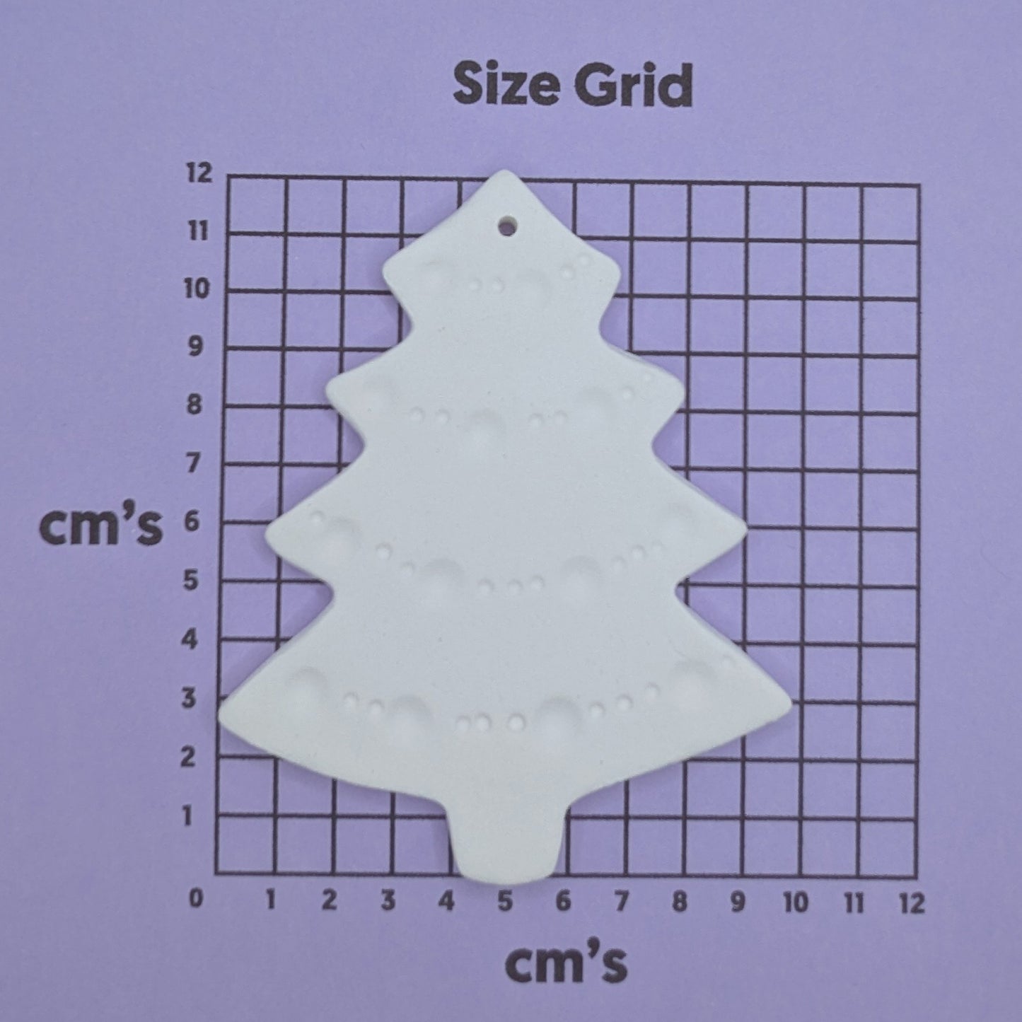 size chart with christmas tree clay decoration on it to show size