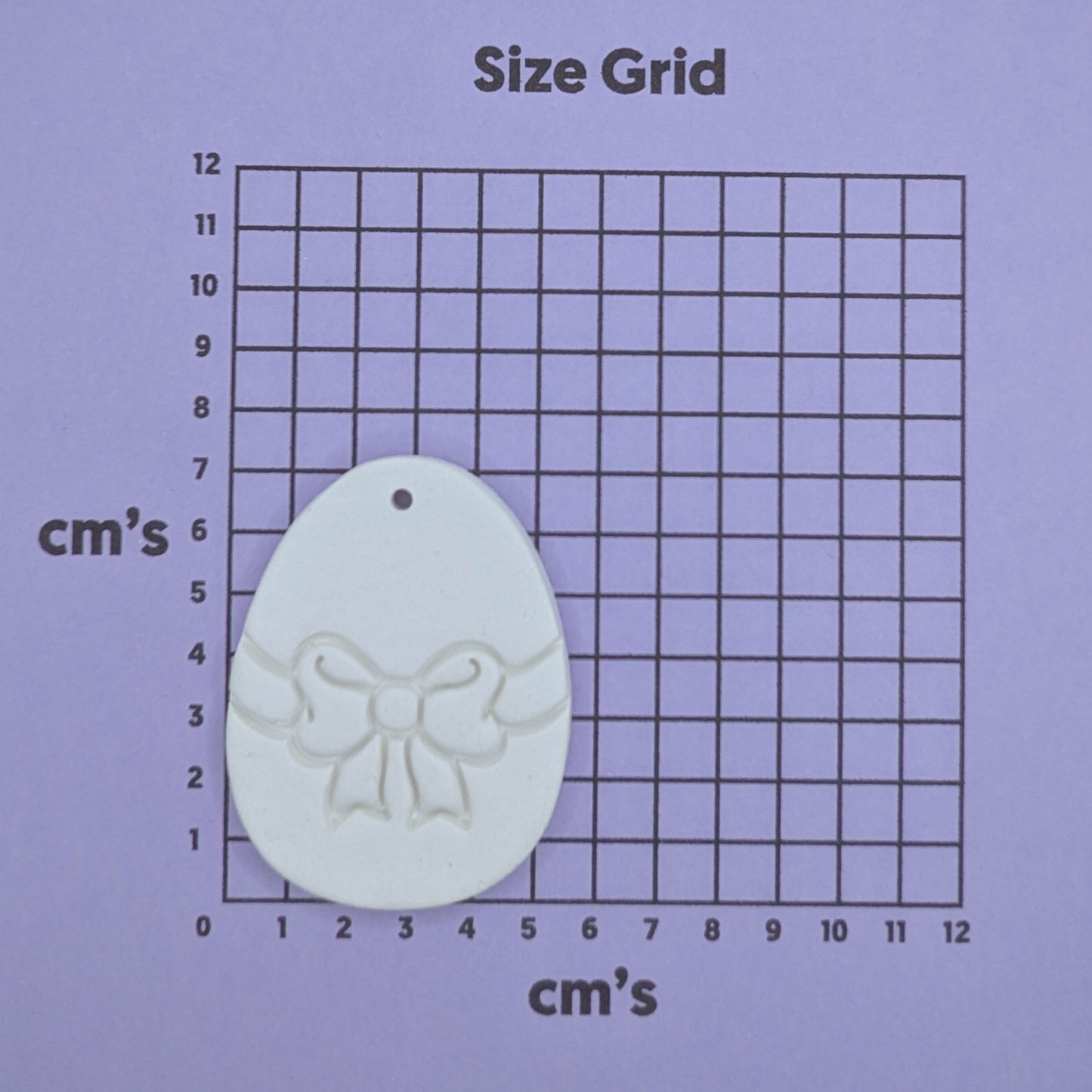 size chart with white easter egg decoration on it