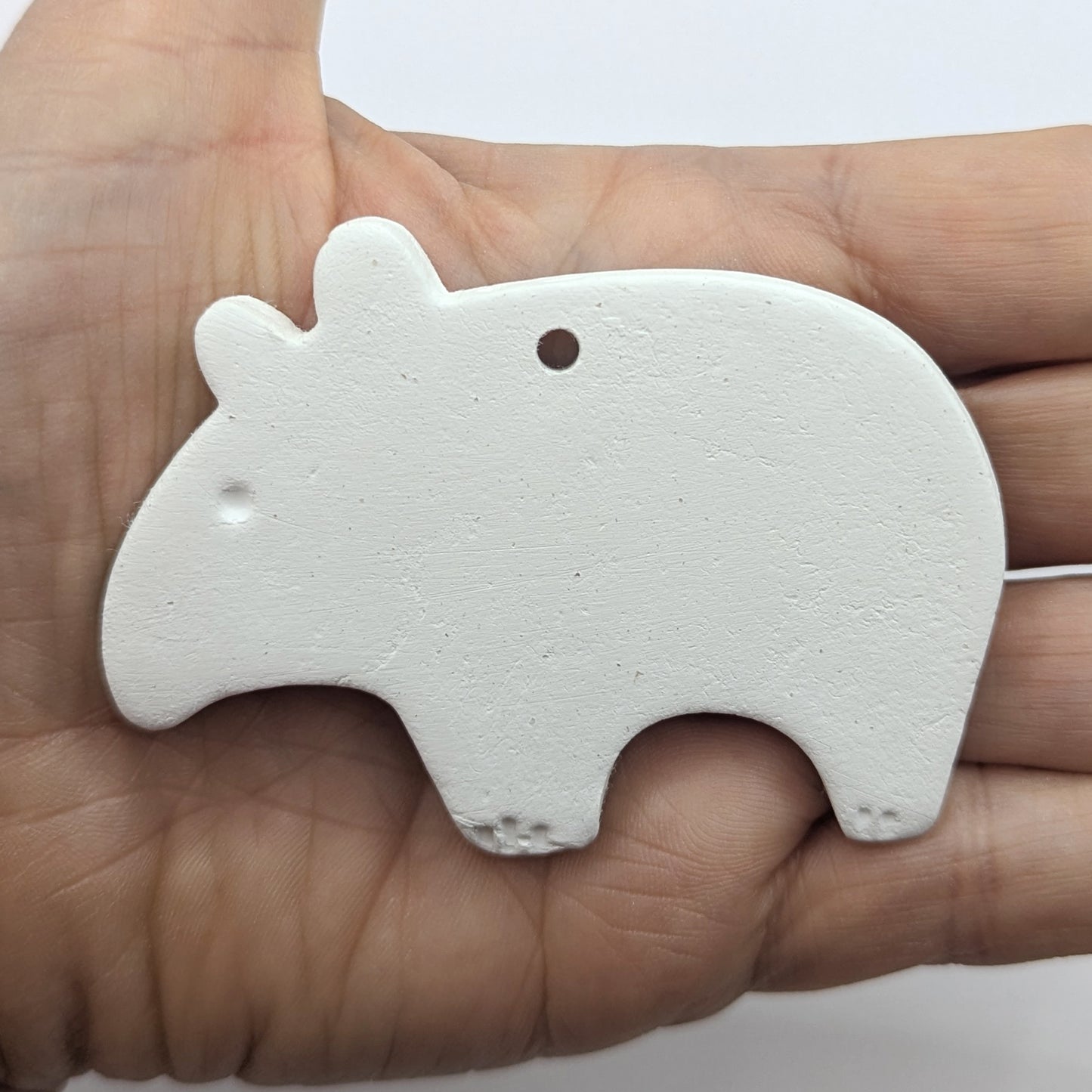 clayed decoration in the shape of a tapir, with little claws and eyes stamped into the clay