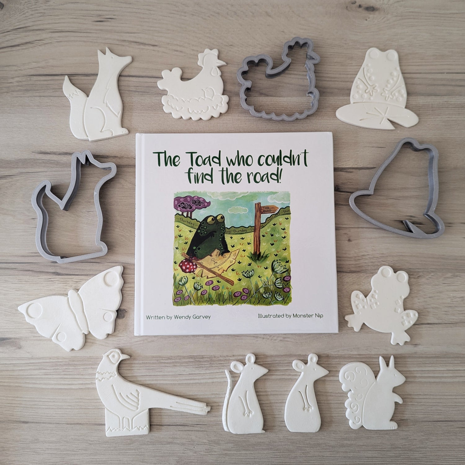 The toad who couldn't find the road book cover and 9 clay animal decorations, plus 3 cutters used to make the decorations, written by Wendy Garvey