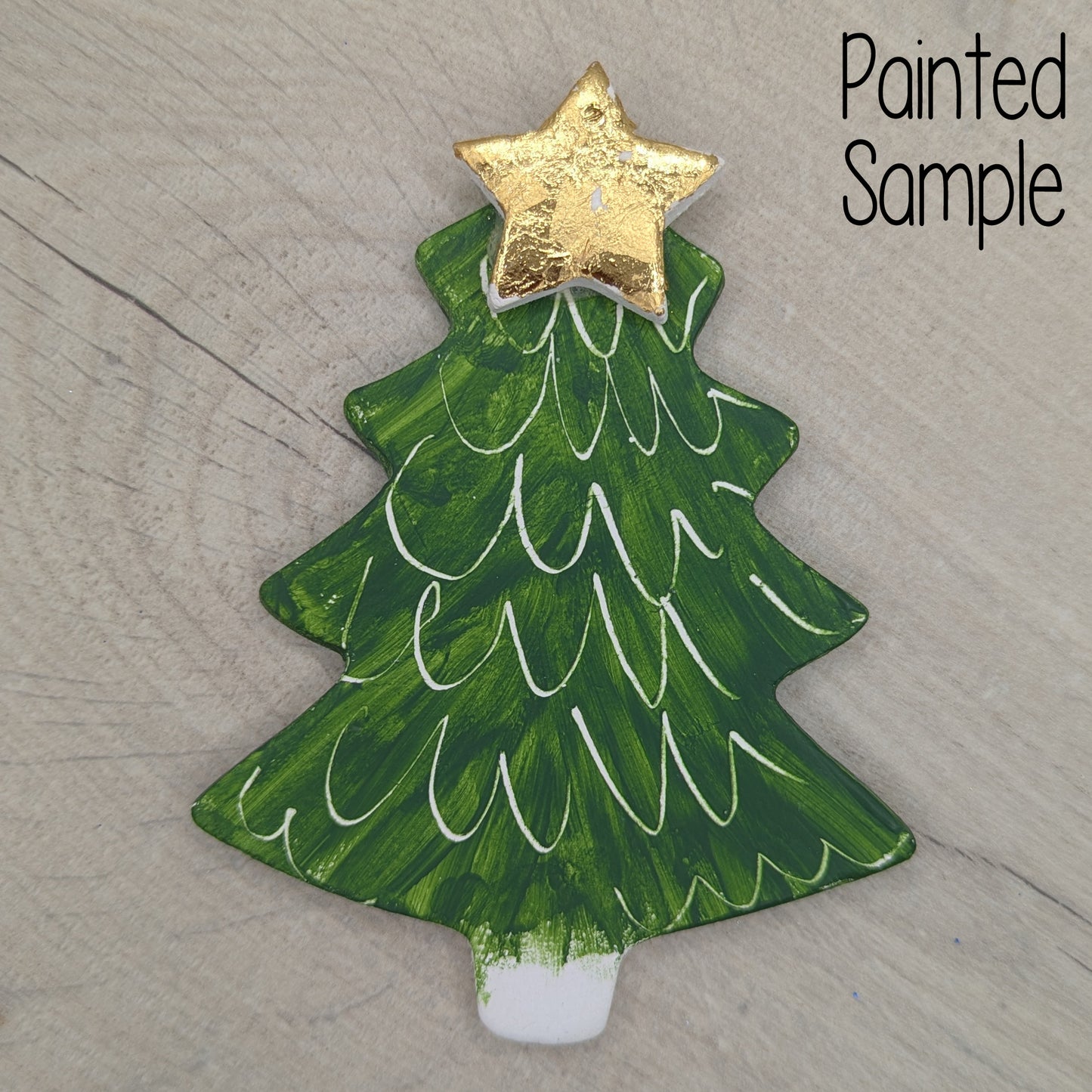 painted Christmas tree clay decoration painted deep green with a gold star on top
