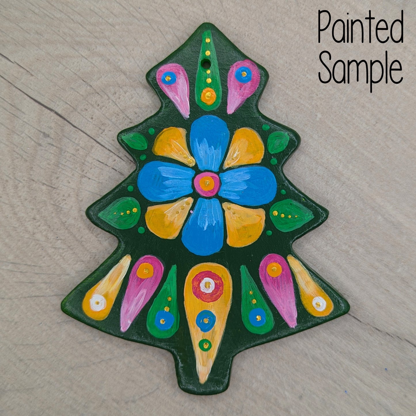Christmas tree decoration painted with a colorful flower design in yellow, pinks, blue and deep green