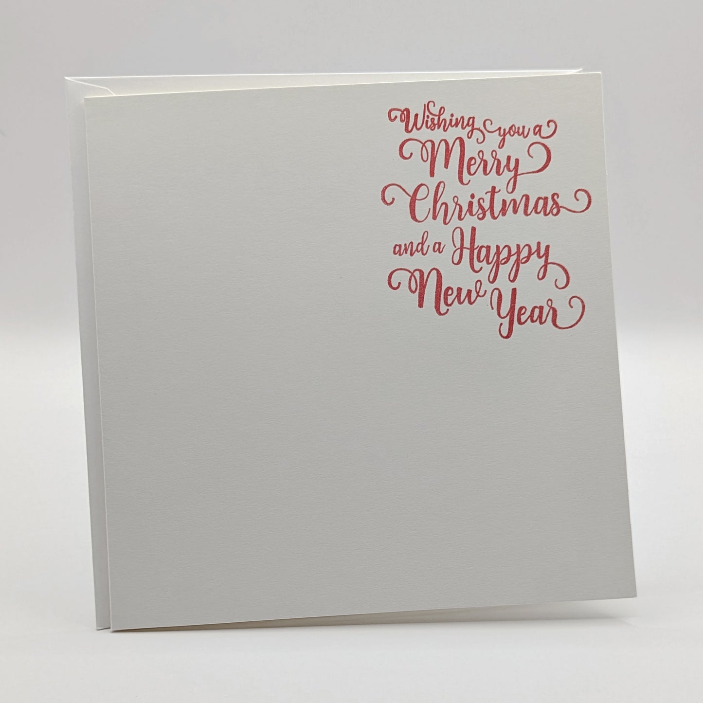 wishing you a merry Christmas and a happy new year, stamped in red ink onto a white card, comes with matching envelope