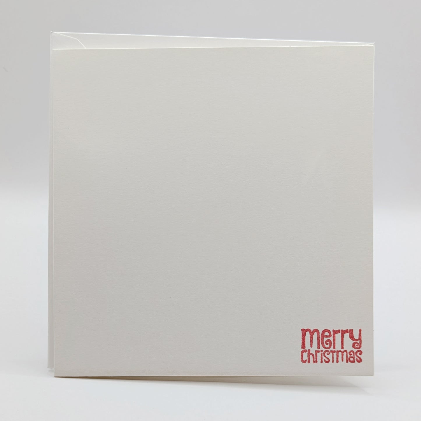 merry Christmas in a modern font, stamped in red ink onto a white card comes with matching envelope