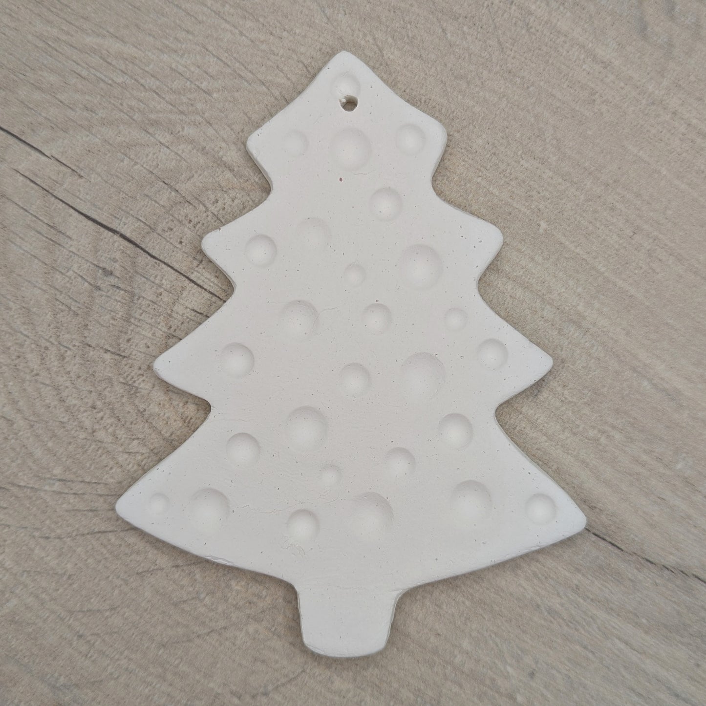 white air dried clay Christmas tree decoration with bauble / spotted pattern stamped into the clay