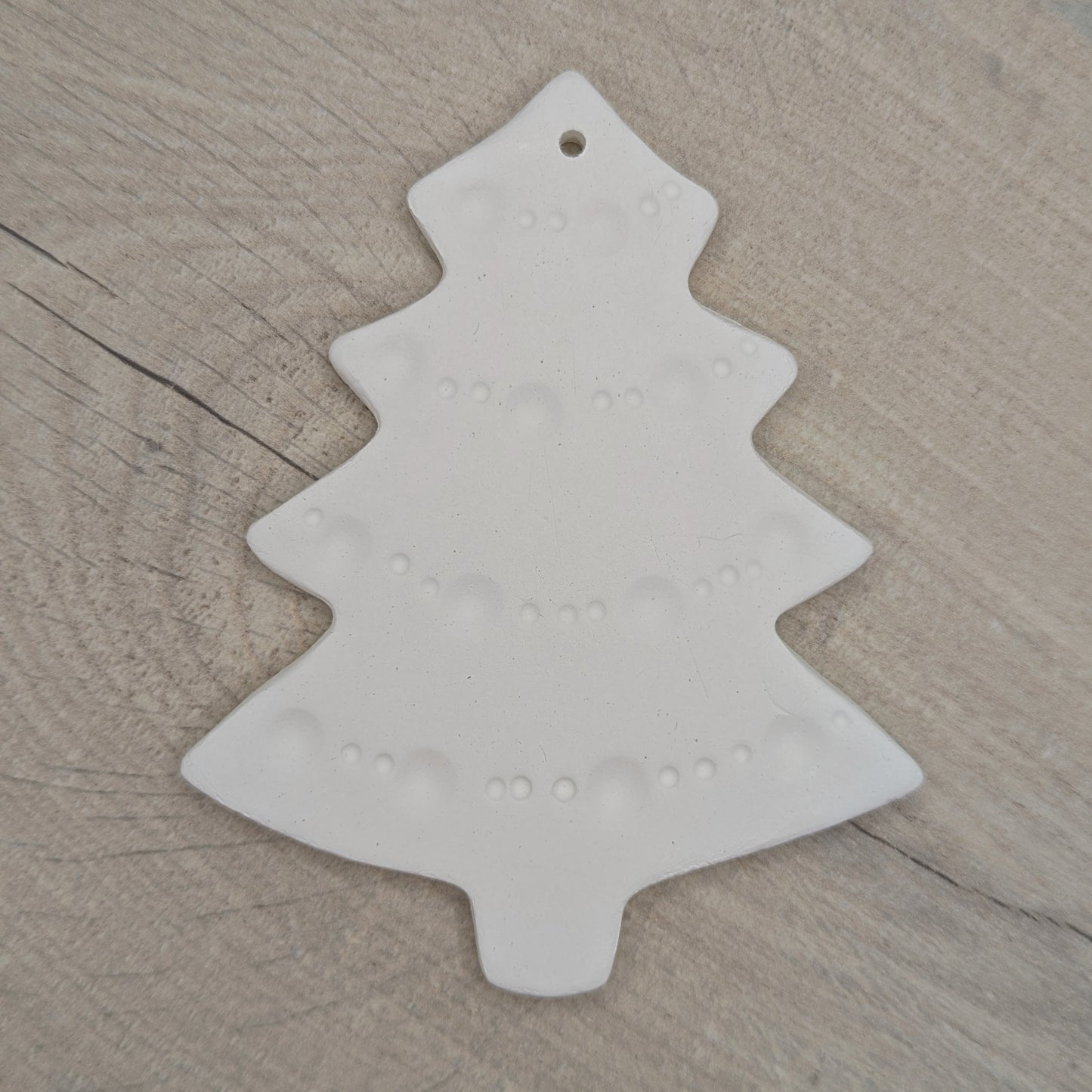 white air dried clay Christmas tree decoration with tinsel pattern stamped into the clay
