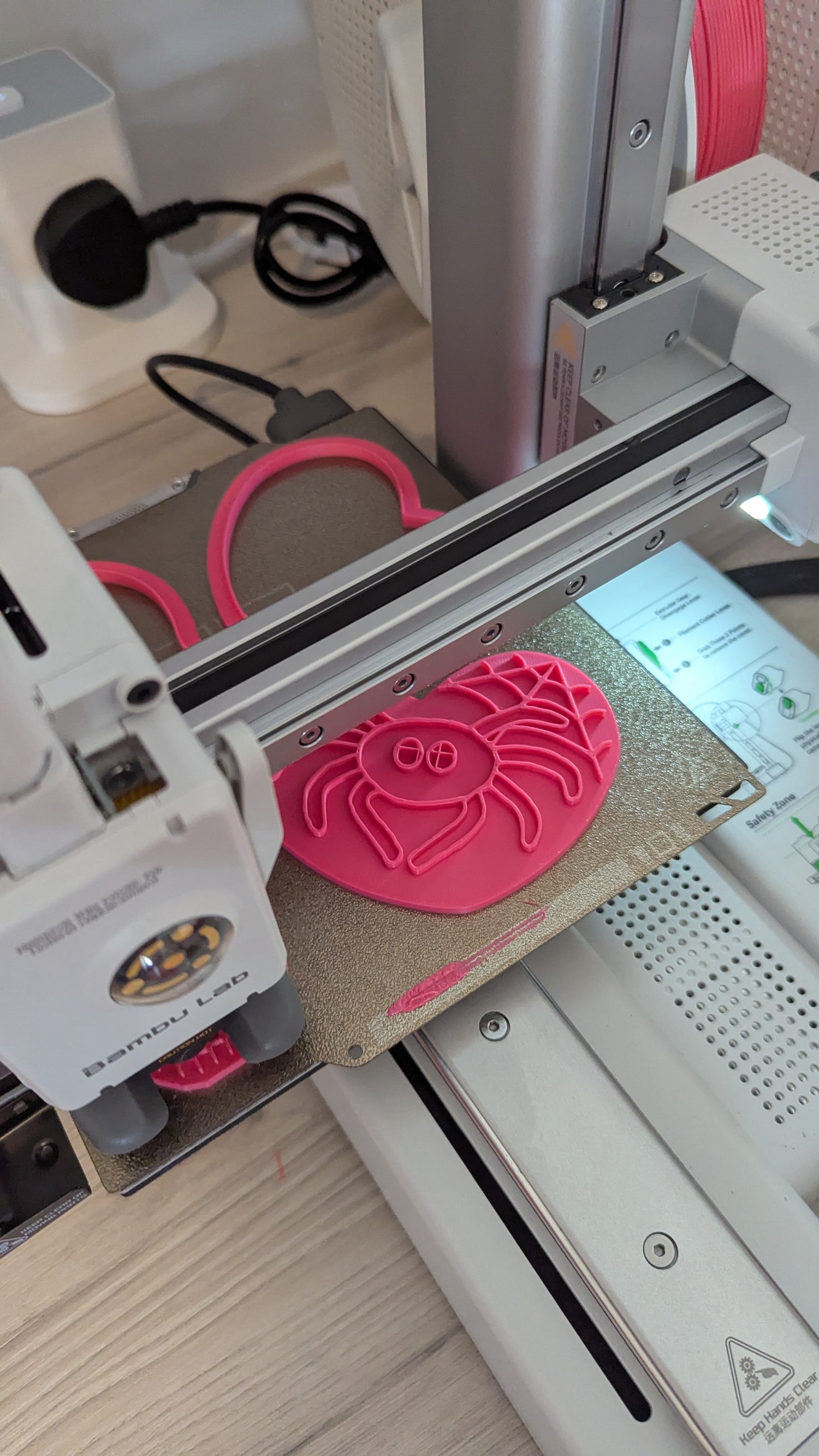 3D printer in operation printing a cookie cutter and stamp