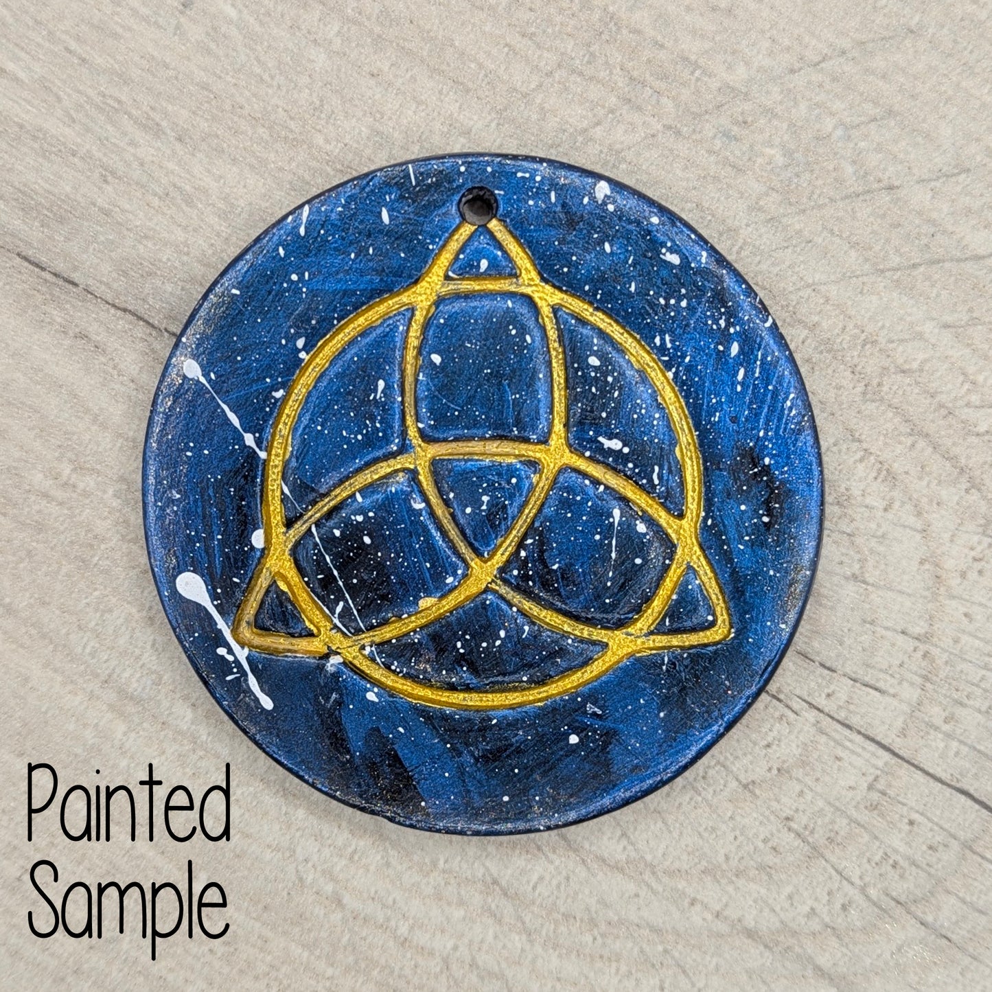 blue and gold painted Triquetra symbol