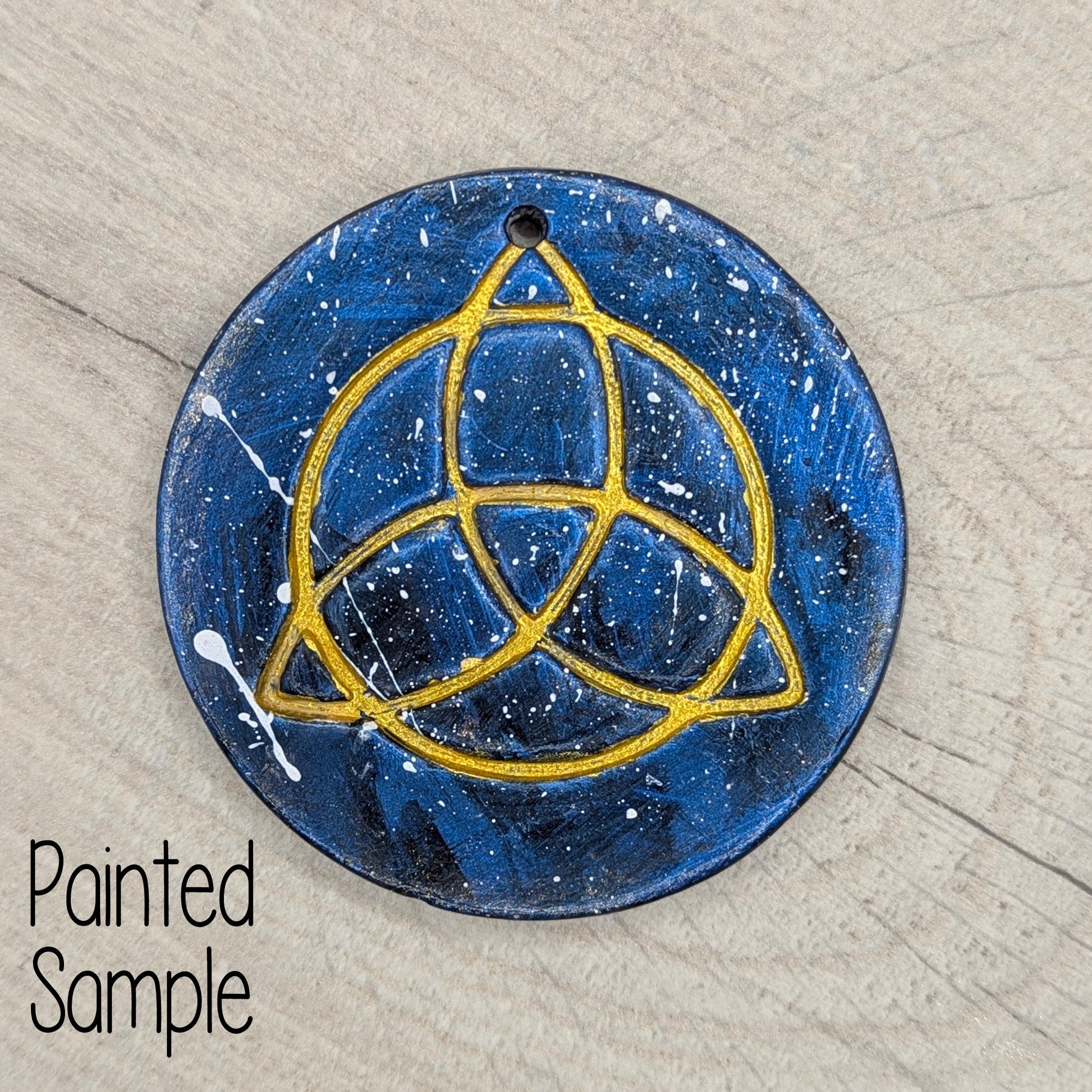 blue and gold painted Triquetra symbol