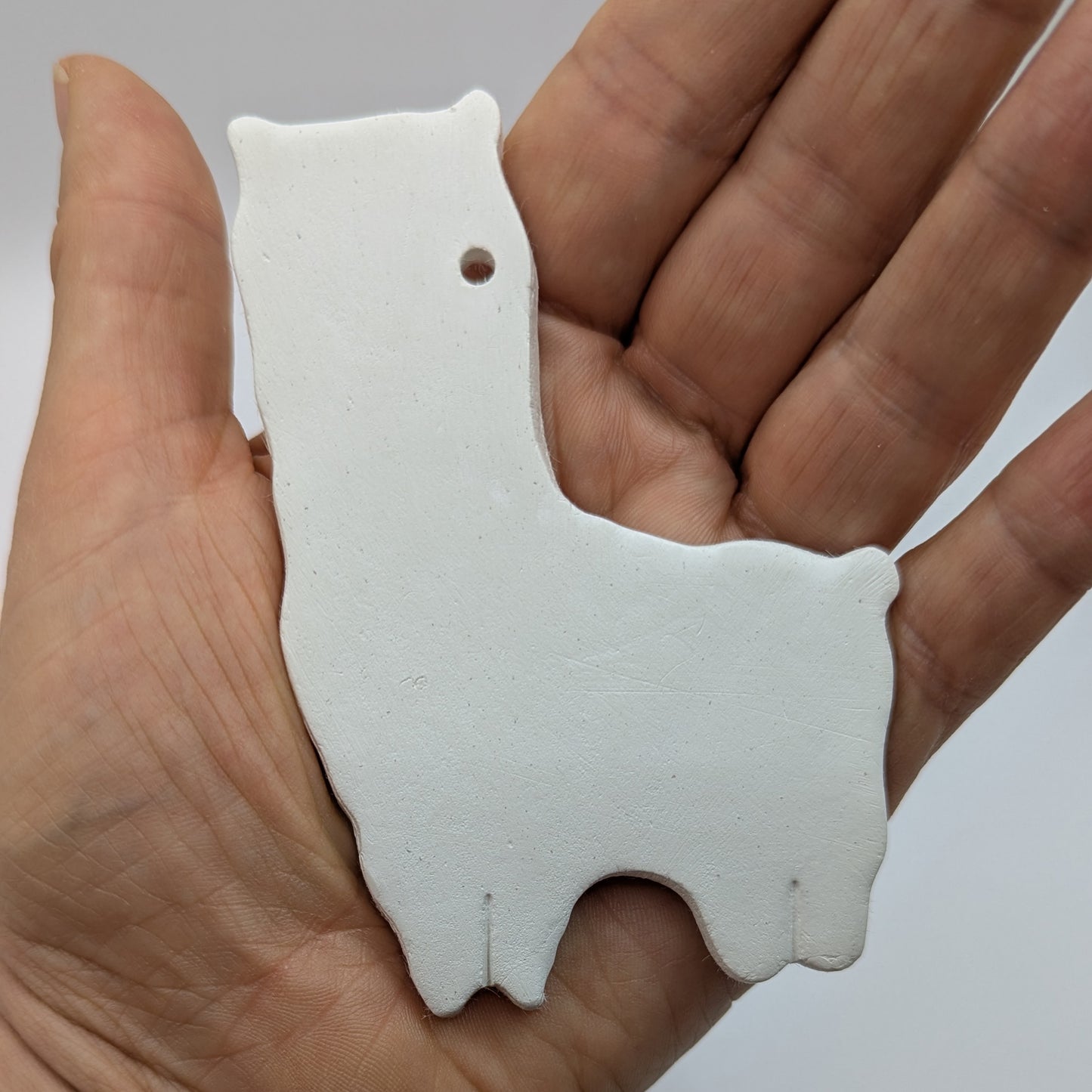 alpaca or llama clay decoration, made of white air dried clay in some ones hand to show size