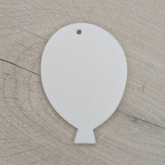 White clay balloon decoration / tag / ornament on wooden background