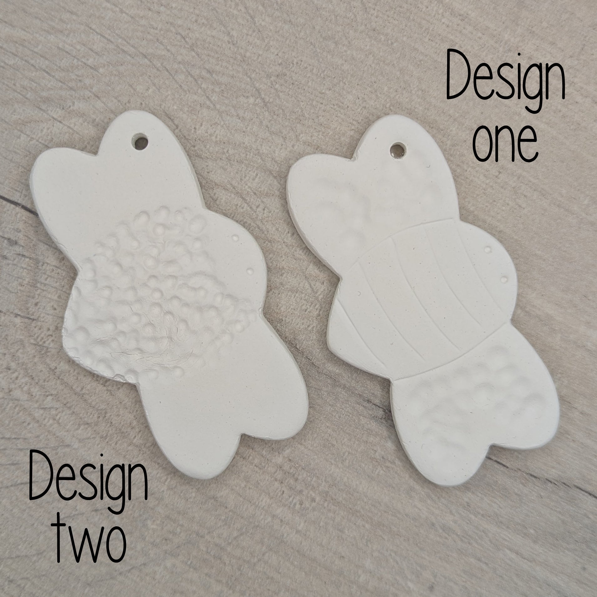 two bumble bee clay decoration to show the two option of patterns available