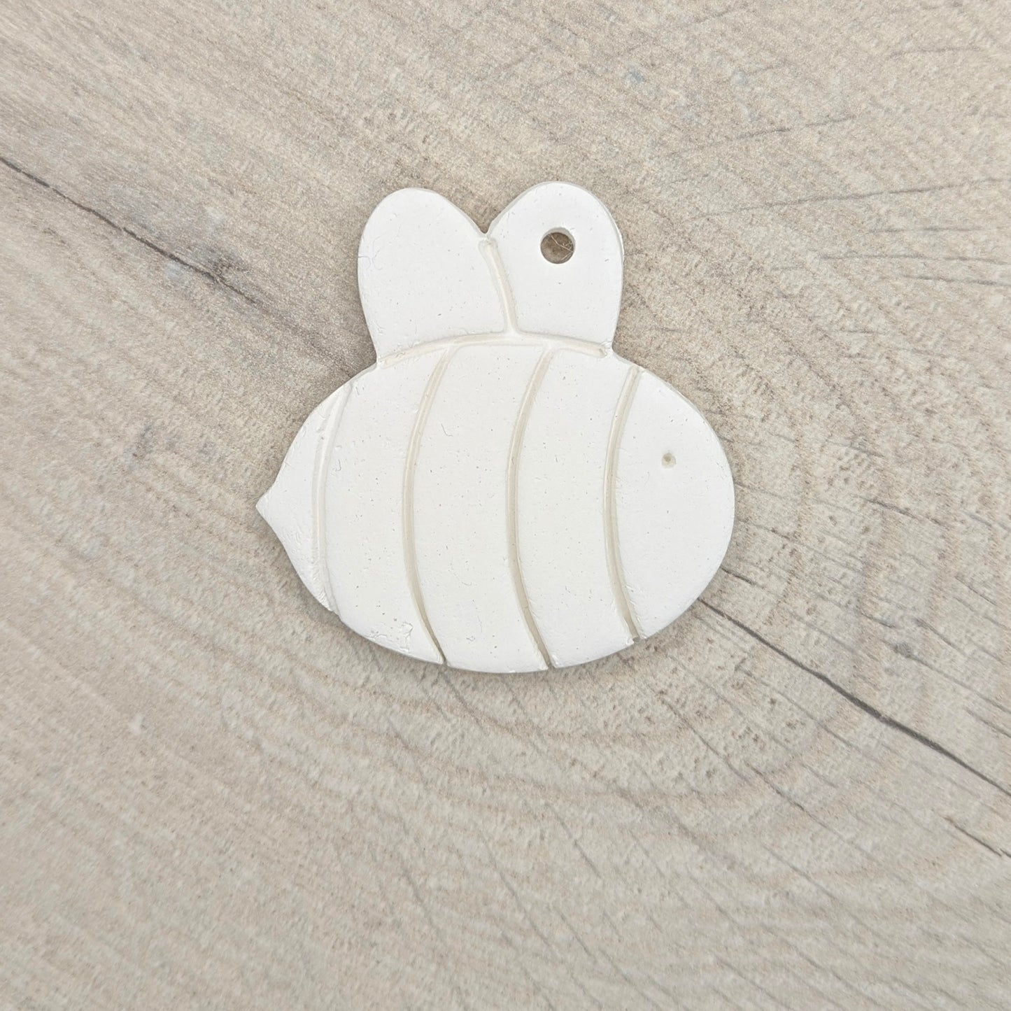 white air dried clay been decoration on a light wooden background