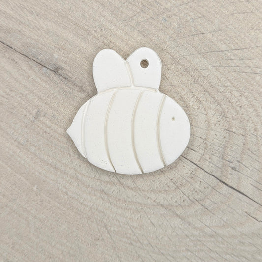 white air dried clay been decoration on a light wooden background