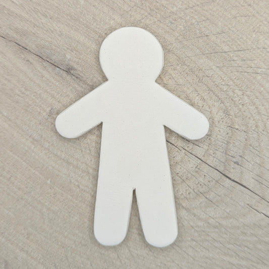white air dried clay male shaped clay decoration on wooden background
