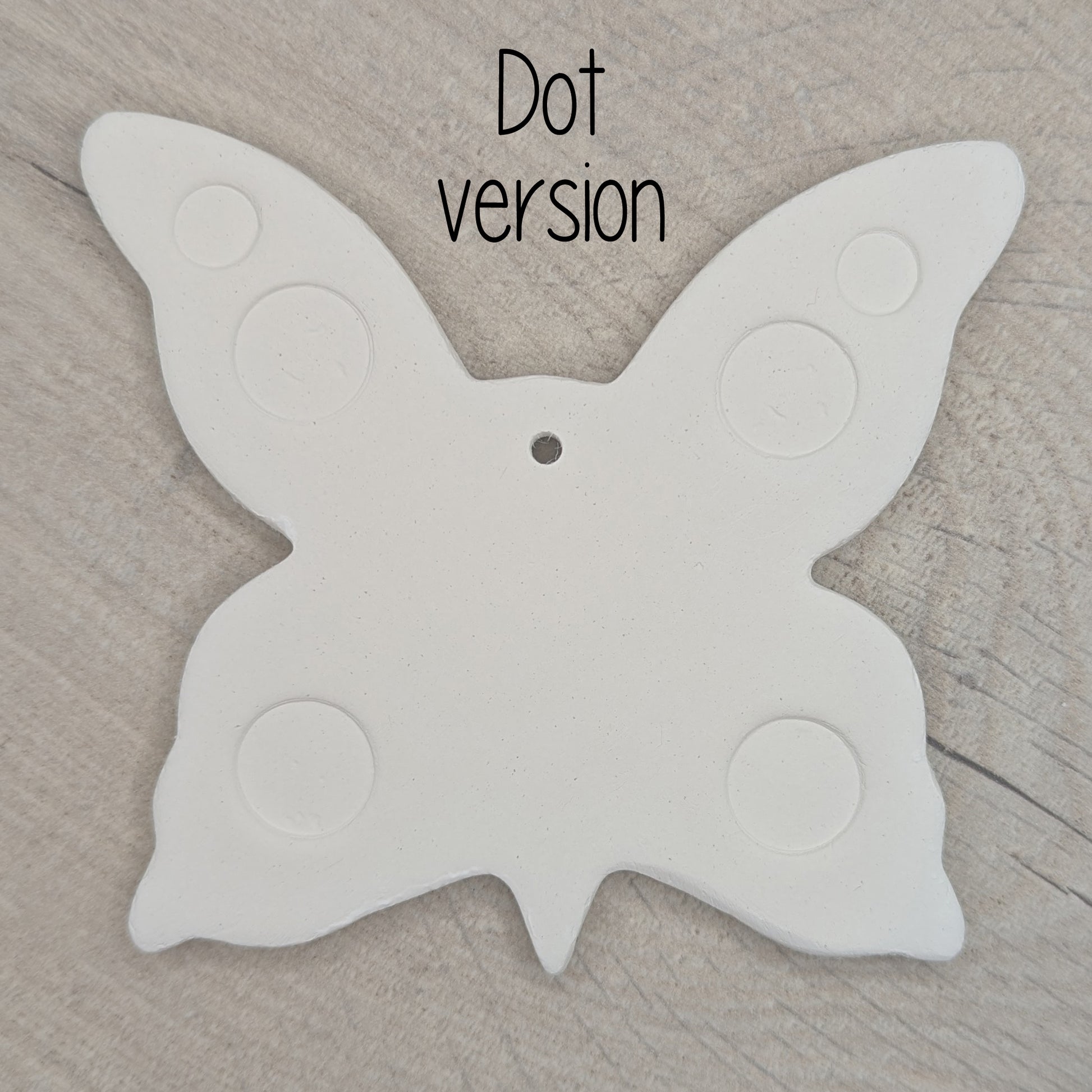 large air dried clay butterfly decoration, with a dotted pattern stamped into the wings