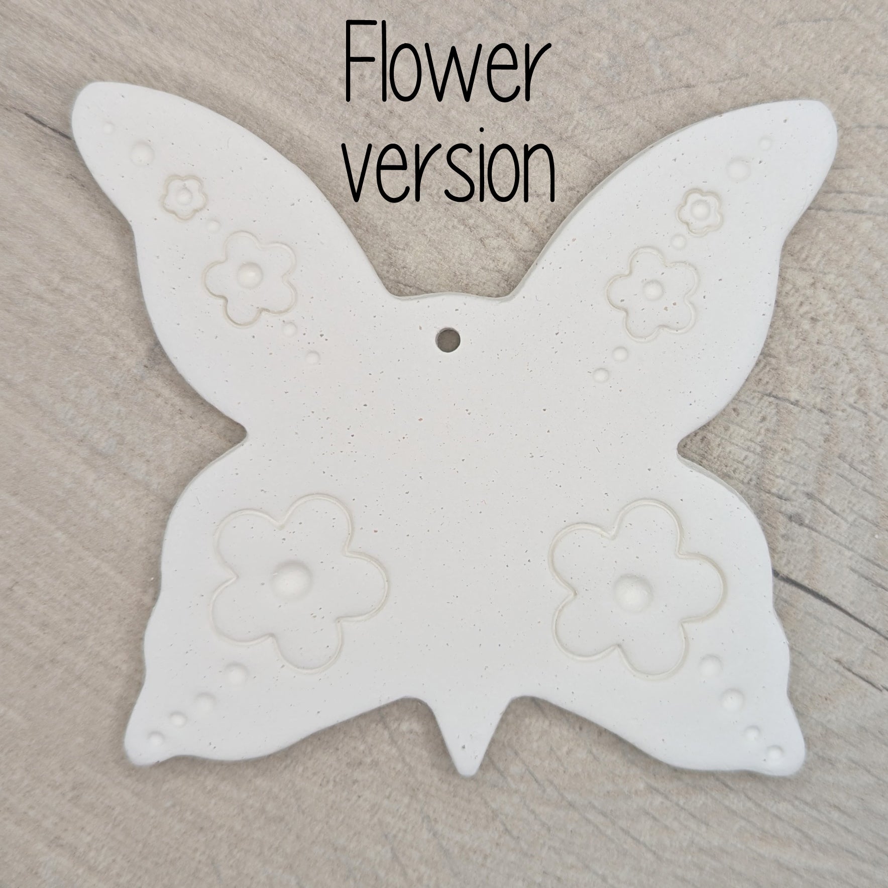 large air dried clay butterfly decoration, with a flower pattern stamped into the wings